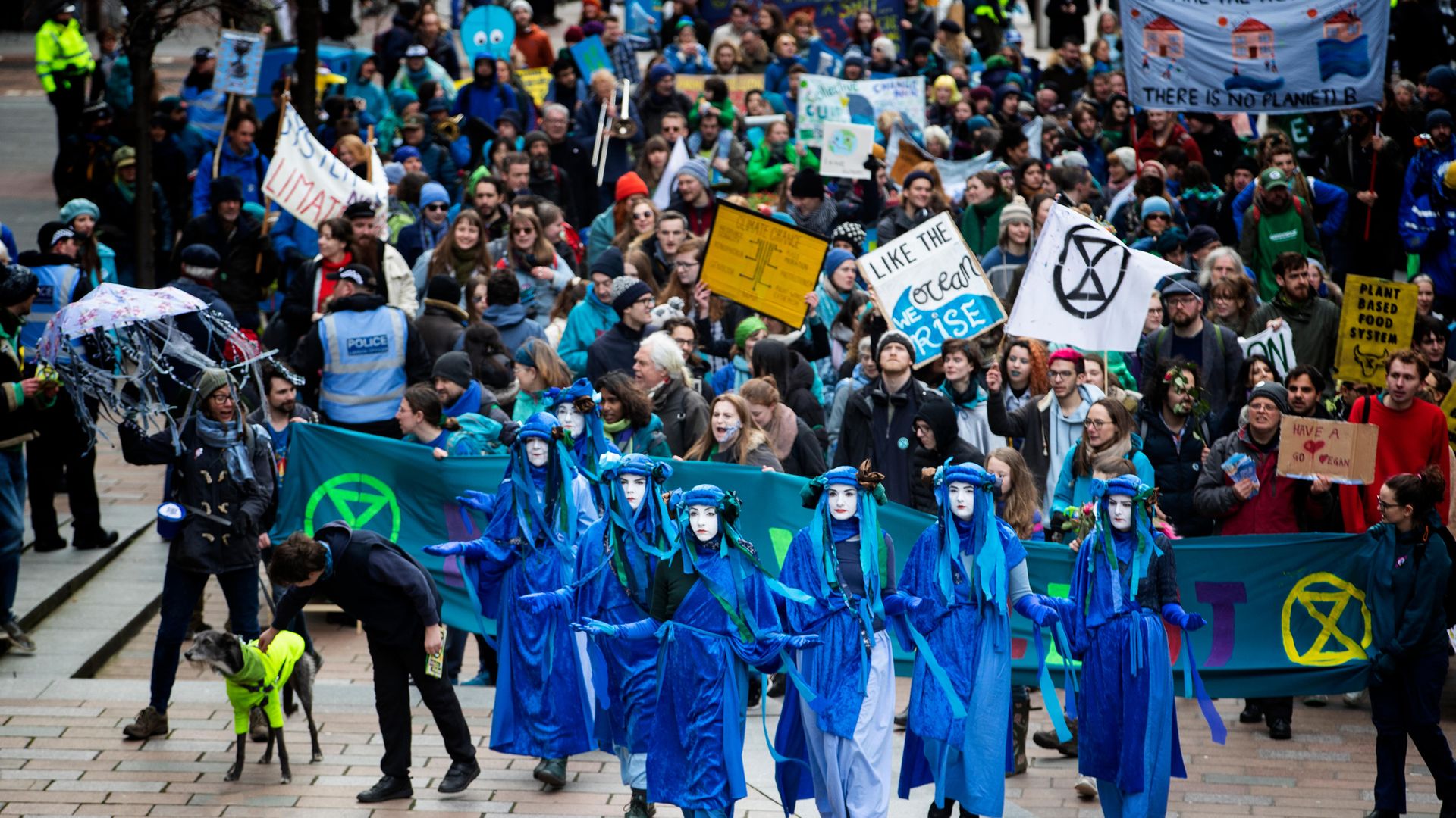 Extinction Rebellion protesters head through Glasgow city centre - Credit: PA