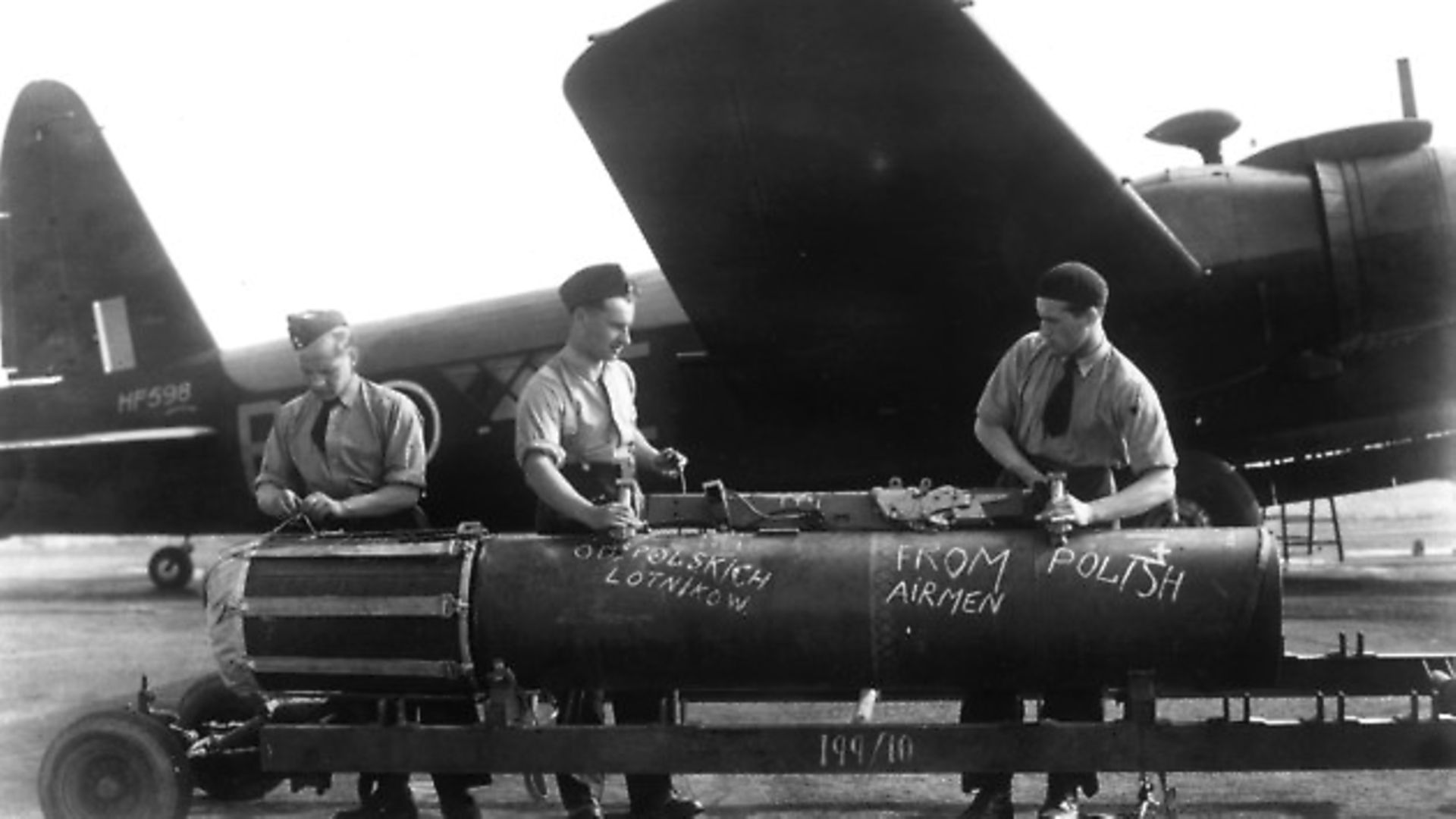 September 1943:  Polish airmen in Britain prepare to commemorate the 4th anniversary of the World War II invasion of Poland by increasing their attacks on the enemy. A giant mine waiting to be loaded onto a bomber at a Polish Bomber Station bears the chalk inscription 'From Polish Airmen'.  (Photo by Keystone Features/Getty Images) - Credit: Getty Images