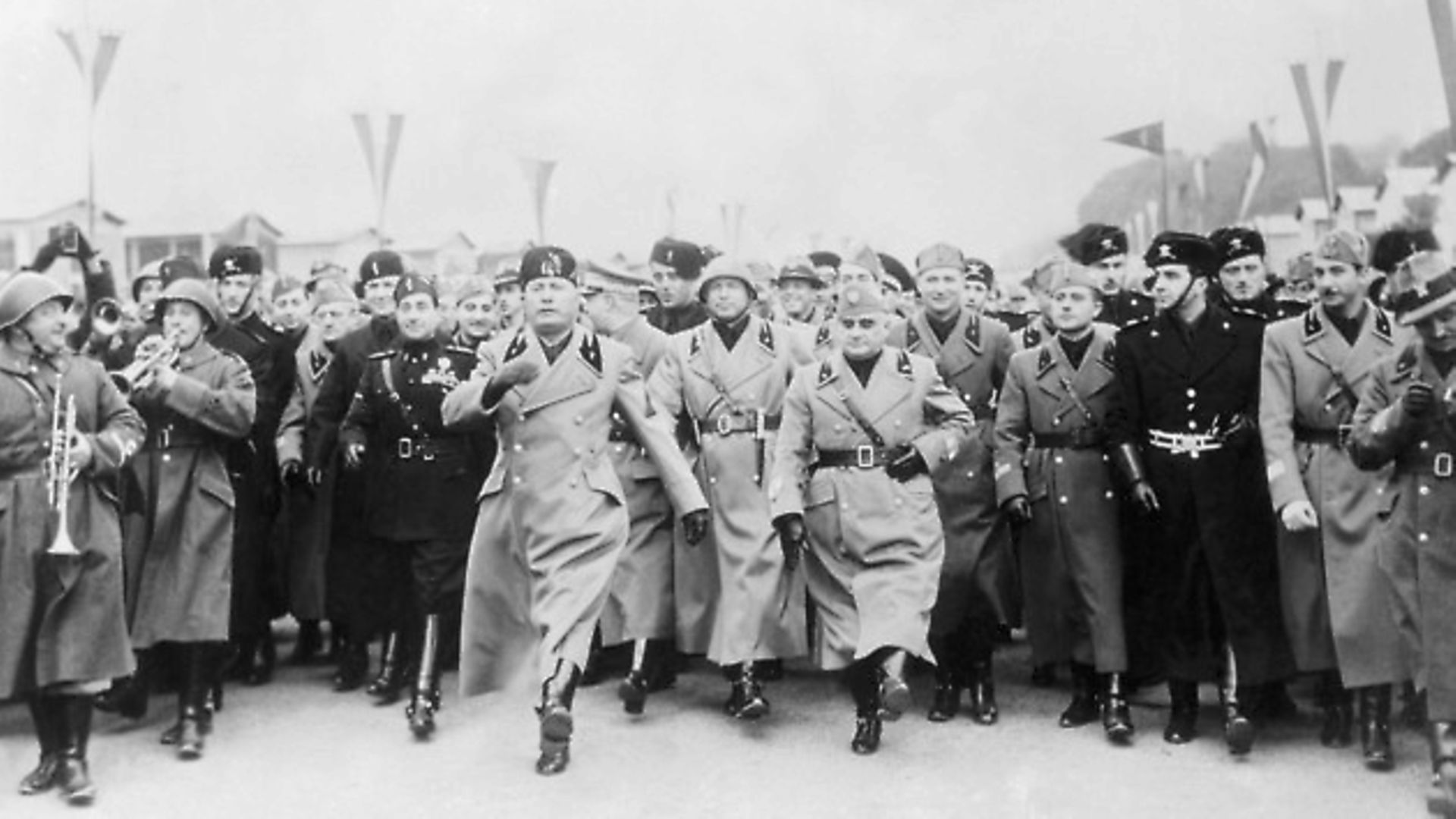 Premiere Benito Mussolini doing the goose step, Germany's ceremonial military march, which he proclaimed the Roman Step - Credit: Bettmann Archive