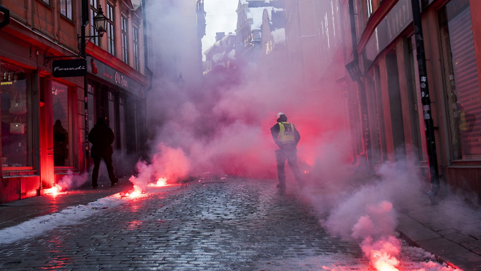 Counter-protesters throw flairs at police as they demonstrate against the neo-nazi Nordic Resistance Movemen, in Stockholm. (Jonathan Nackstrand/AFP/Getty Images) - Credit: AFP/Getty Images