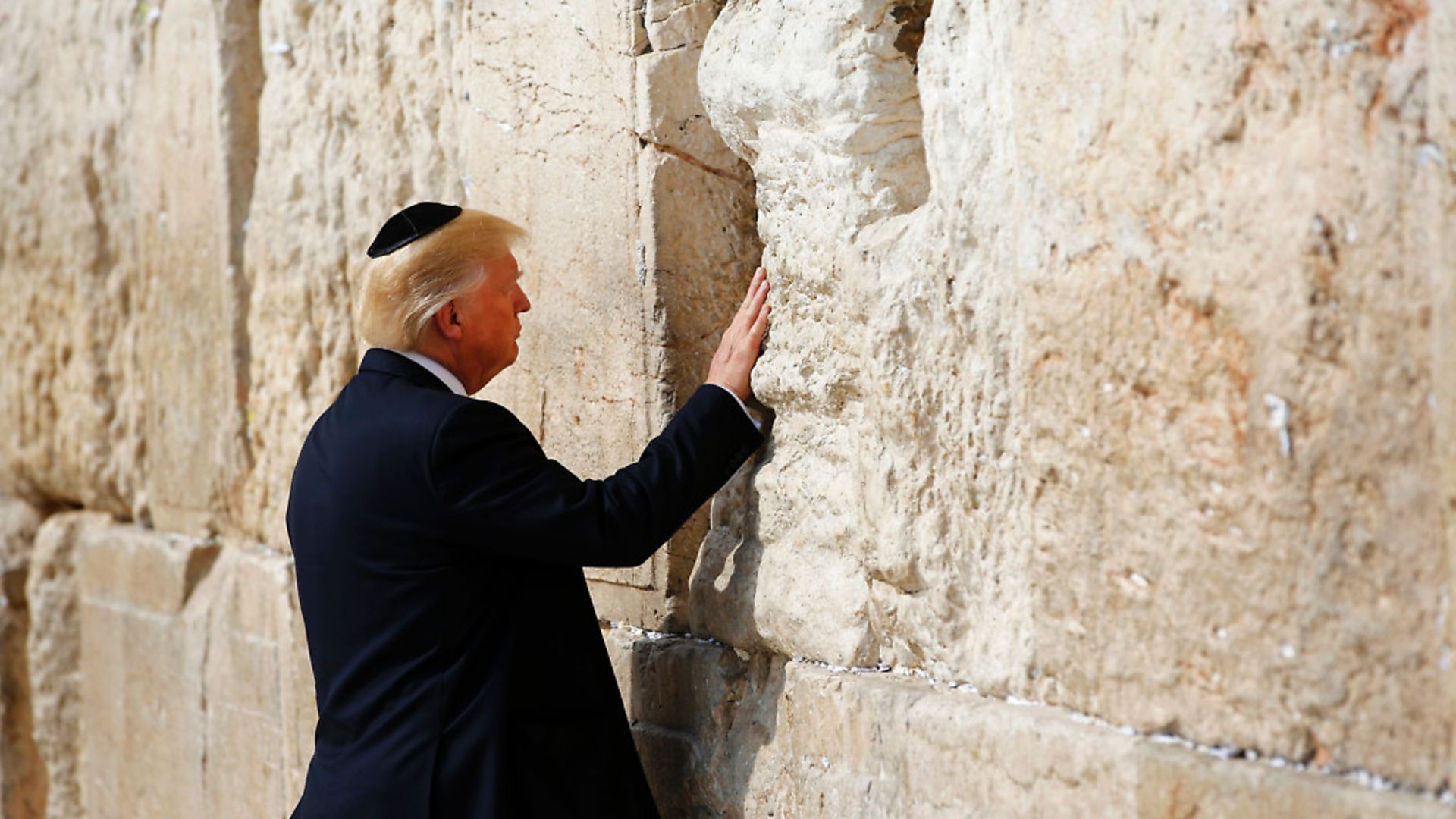 US President Donald Trump visits the Western Wall, the holiest site where Jews can pray, in Jerusalems Old City on May 22, 2017. 


 / AFP PHOTO / POOL / RONEN ZVULUN        (Photo credit should read RONEN ZVULUN/AFP/Getty Images) - Credit: AFP/Getty Images