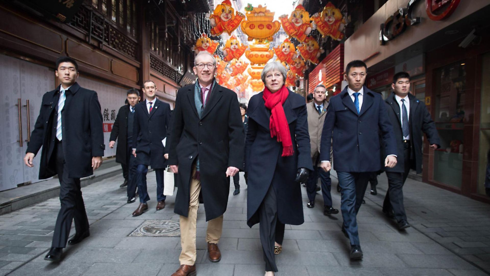 Prime Minister Theresa May and her husband Philip walk through a market after visiting the Yu Yuan Temple Garden in Shanghai today as part of her two day visit to the Chinese city (Pictures: PA Wire) - Credit: PA Wire/PA Images