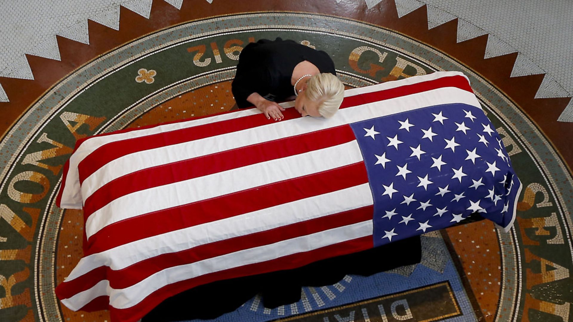 Cindy McCain, wife of Sen. John McCain kisses the former Senator's casket during a memorial service in Arizona.Photo by Ross D. Franklin-Pool via Getty Images - Credit: Getty Images