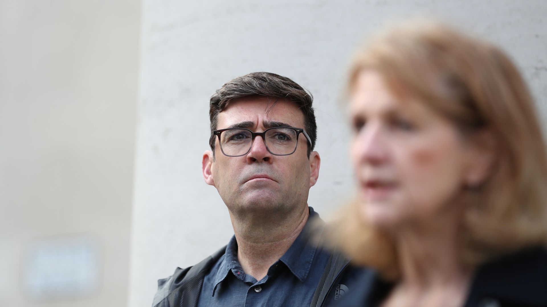 Greater Manchester mayor Andy Burnham listens as deputy mayor Baroness Beverley Hughes speaks to the media outside the Central Library in Manchester, he has threatened legal action if Tier 3 restrictions are imposed without agreement. - Credit: PA