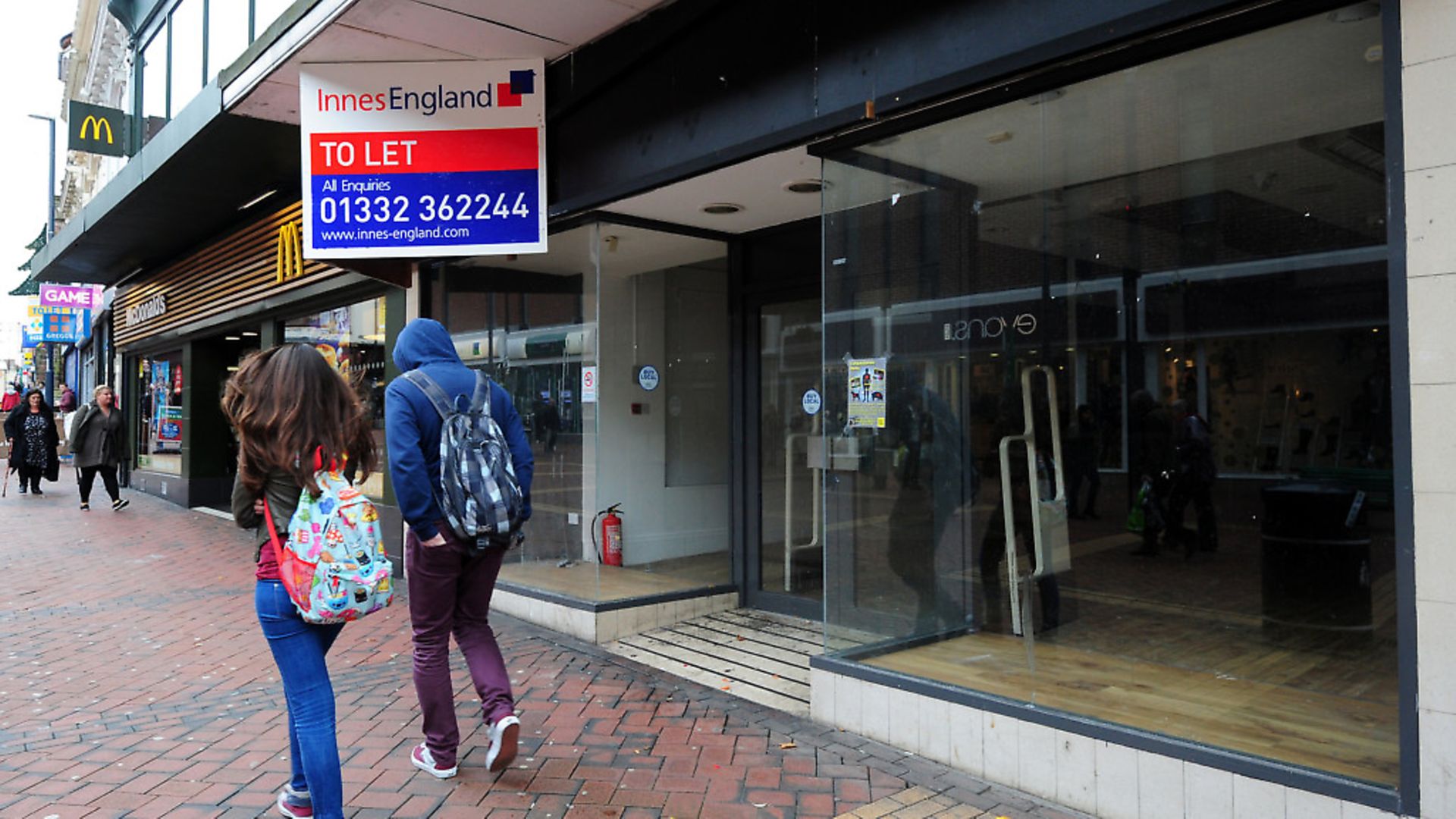 Shoppers walk past an empty unit on the high street. Photograph: Rui Vieira/PA. - Credit: PA Archive/PA Images