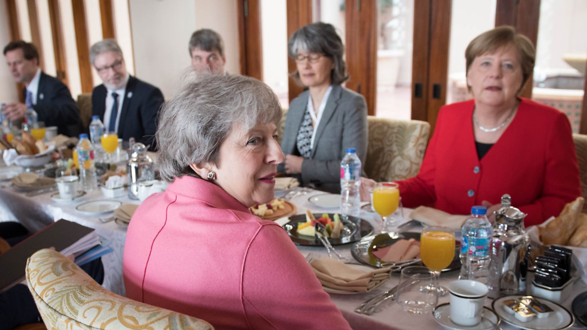 Theresa May (centre) has a breakfast meeting with German Chancellor Angela Merkel (right) at the EU-League of Arab States Summit in Sharm El-Sheikh. Photograph: Stefan Rousseau/PA Wire - Credit: PA