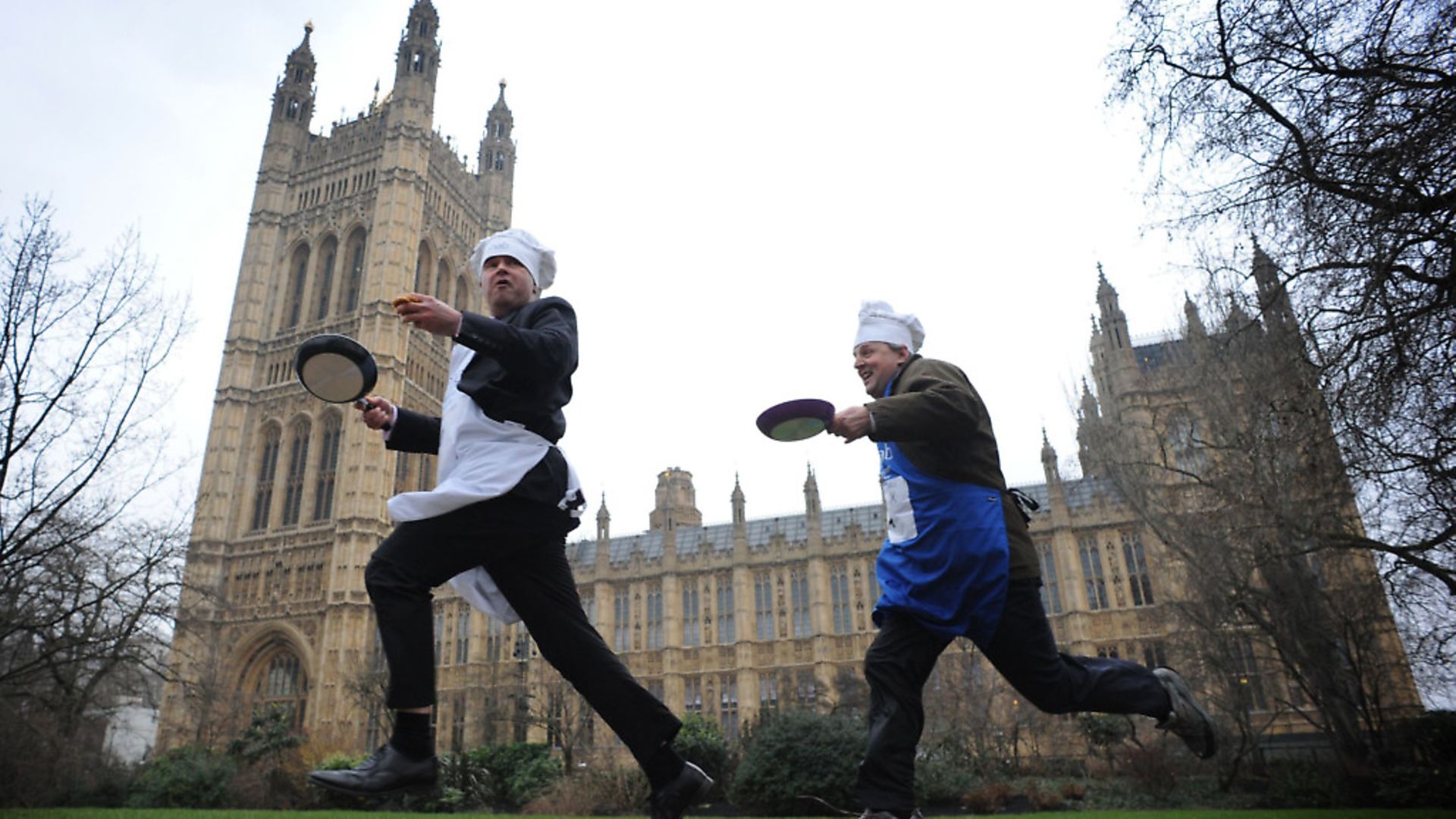 MPs, Lords and members of the press take part in pancake races outside the Houses of Parliament in London. Photograph: Stefan Rousseau/PA. - Credit: PA Archive/PA Images