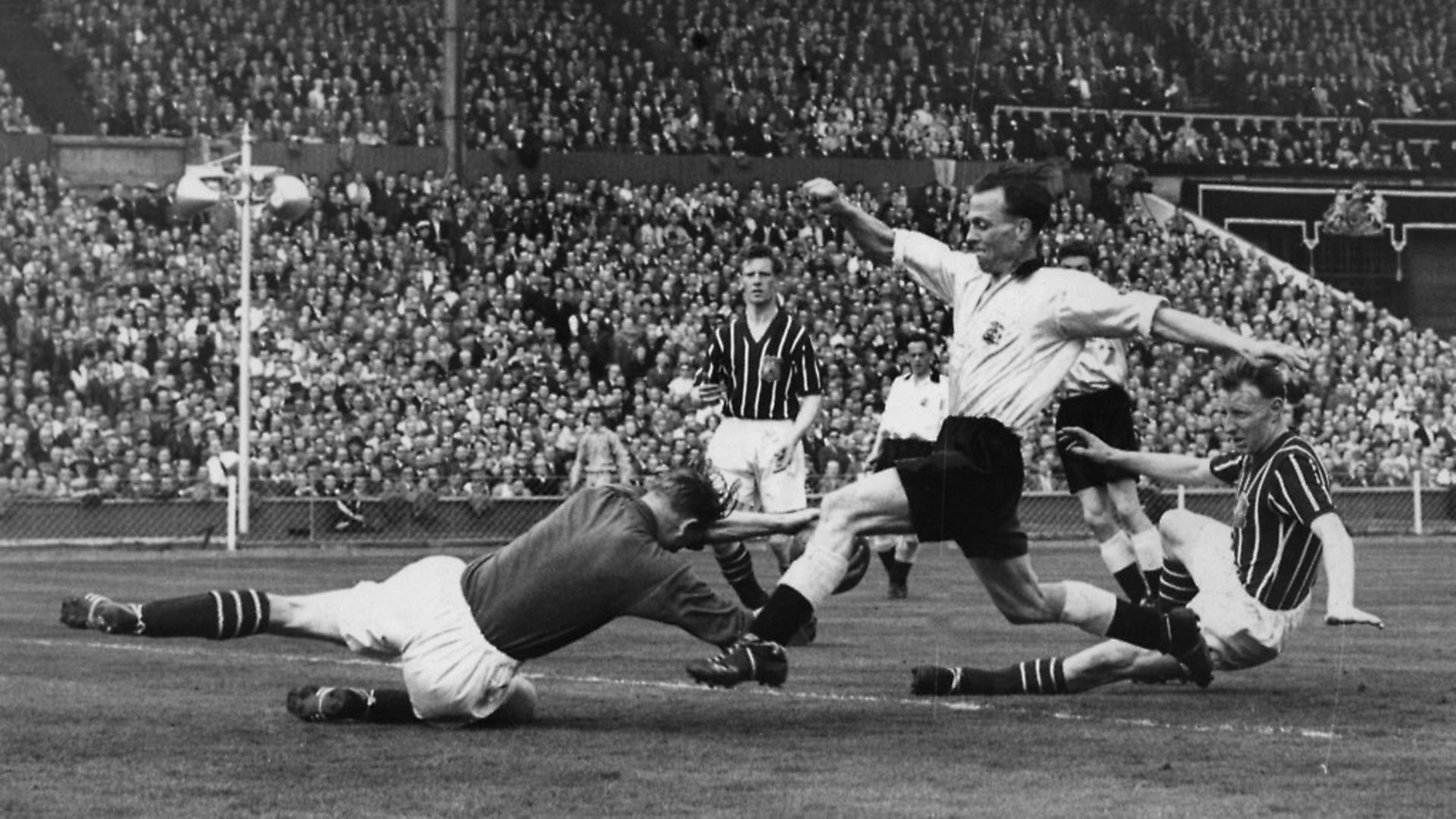 Manchester's goalkeeper Bert Trautmann dives at the feet of Birmingham's Murphy during the match. It was whilst making this save that Trautmann unknowingly broke his neck. Picture: Allsport Hulton/Archive - Credit: Getty Images
