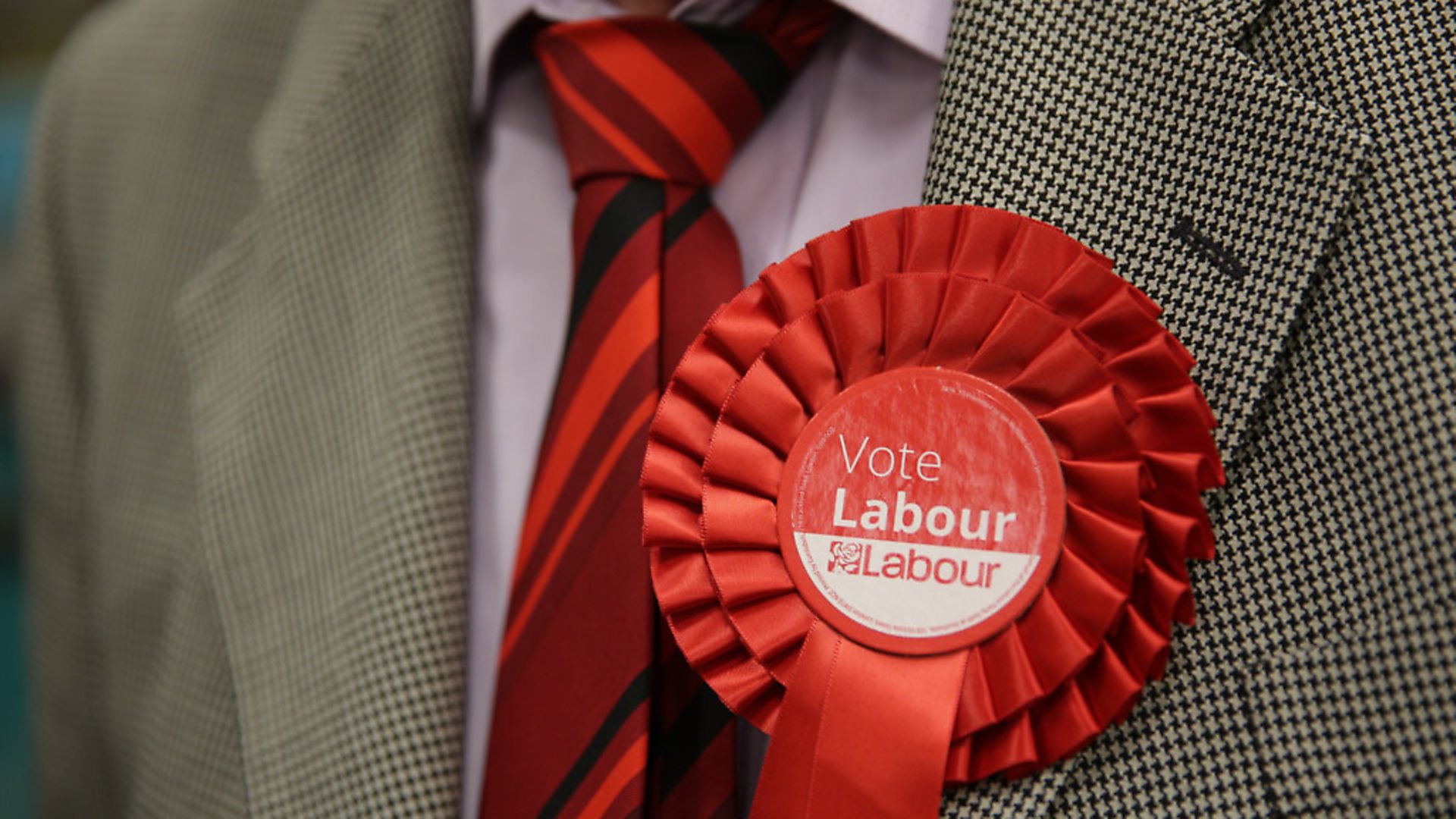 A Labour rosette is worn in support of the party during an election count. Photograph: Daniel Leal-Olivas/PA. - Credit: PA Archive/PA Images