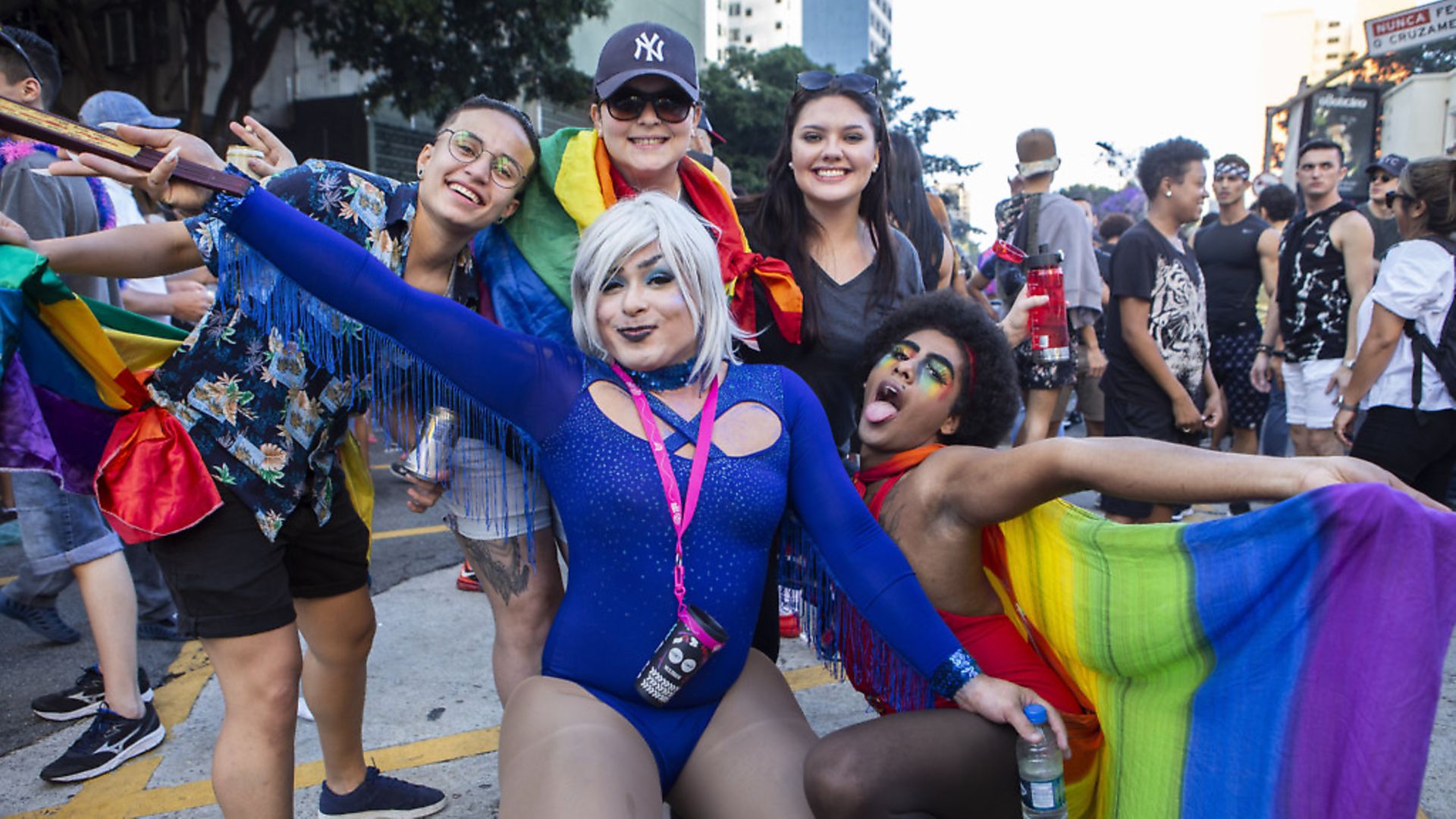 Parade goers attend the Sao Paulo Pride Parade which is celebrating the 50th anniversary of the Stonewall riots on June 23, 2019 in Sao Paulo, Brazil. (Photo by Rebeca Figueiredo Amorim/Getty Images) - Credit: Getty Images
