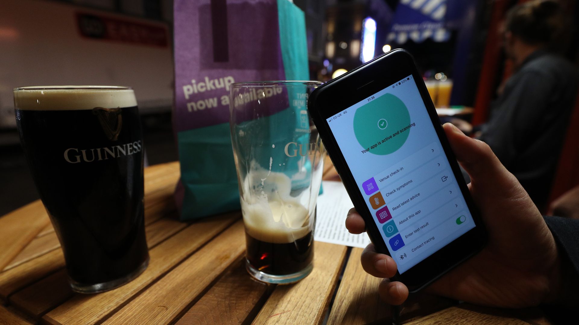 A person uses the NHS coronavirus contact tracing app outside The Coach and Horses pub in Soho, central London, after a range of new restrictions to combat the rise in coronavirus cases came into place in England. - Credit: PA