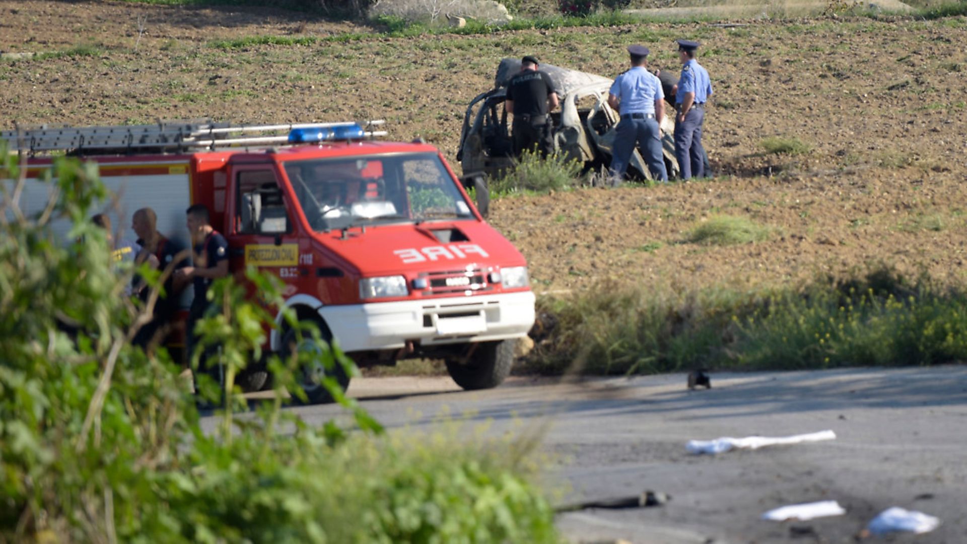 Police inspect the wreckage of a car bomb believed to have killed journalist and blogger Daphne Caruana Galizia close to her home in Bidnija, Malta. Photo :STR/AFP/Getty Images - Credit: AFP/Getty Images