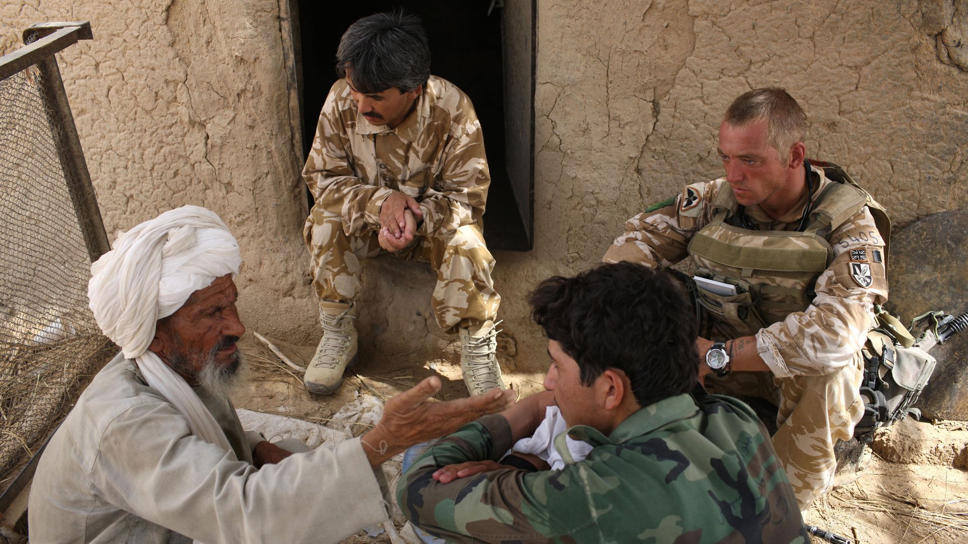 A British solider and his interpreters question an Afghan in Kandahar in 2008 - Credit: Getty Images