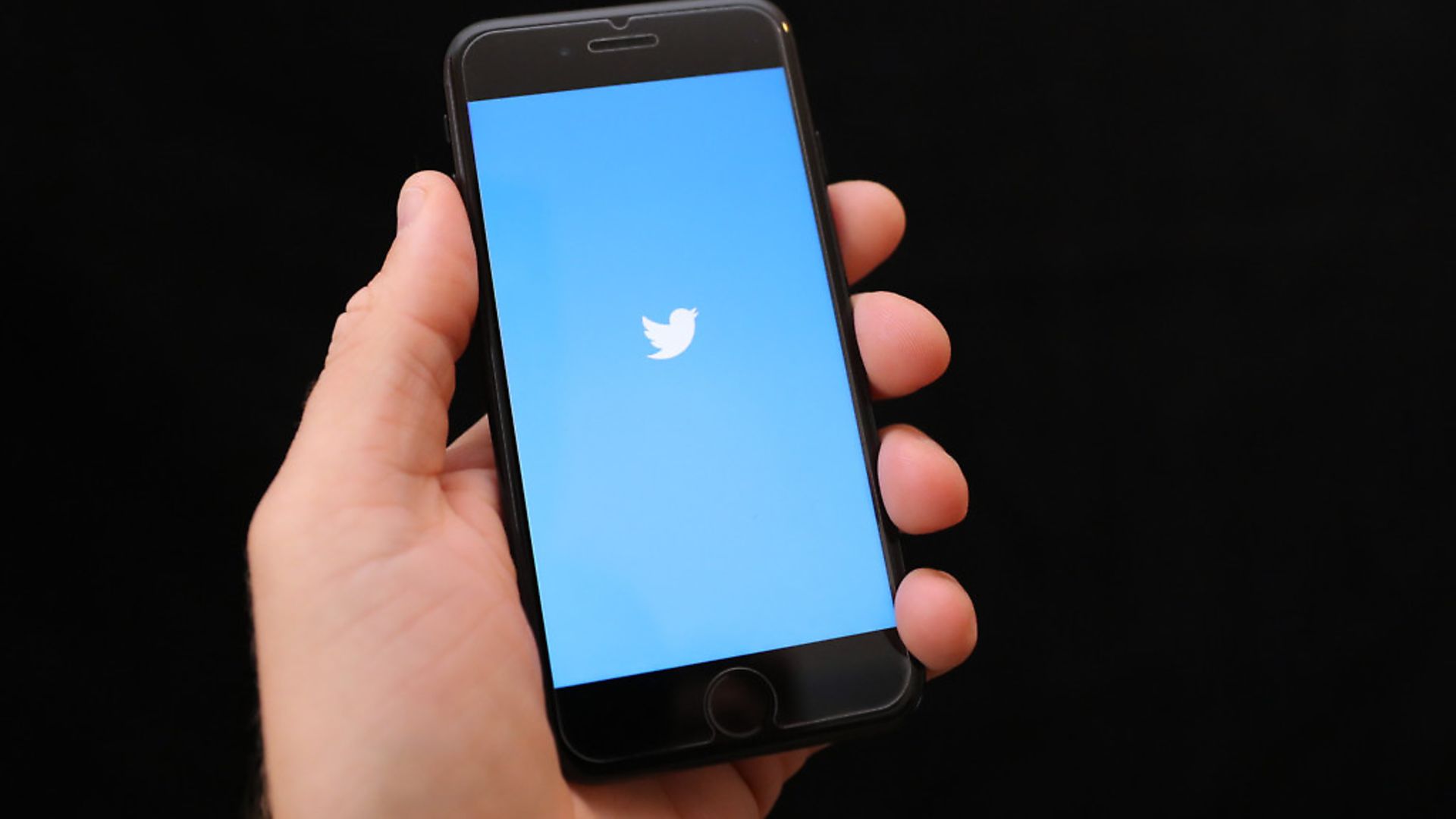 A mobile phone user loads up the Twitter app. Photograph: Andrew Matthews/PA. - Credit: PA Archive/PA Images