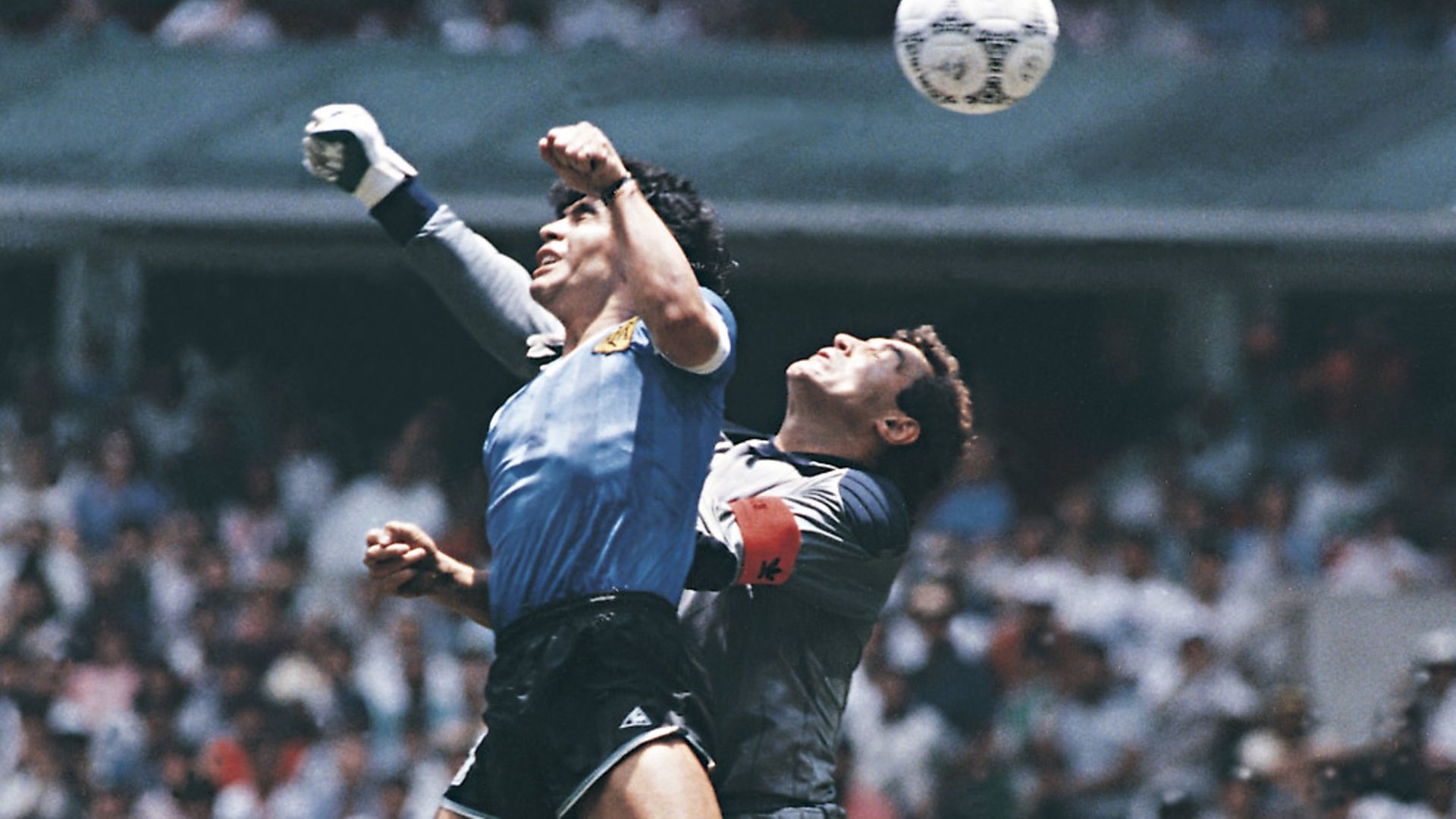 MEXICO CITY, MEXICO - JUNE 22: Diego Maradona of Argentina uses his hand to score the first goal of his team during a 1986 FIFA World Cup Quarter Final match between Argentina and England at Azteca Stadium on June 22, 1986 in Mexico City, Mexico. Maradona later claimed that the goal was scored by 'The Hand Of God'. (Photo by Archivo El Grafico/Getty Images) - Credit: Getty Images