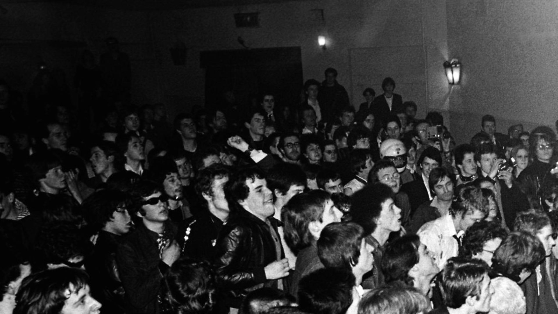 Photo of Paul SIMONON and Joe STRUMMER and CLASH; Joe Strummer and Paul Simonon (jumping) performing live onstage in small venue, showing crowds  (Photo by Ian Dickson/Redferns) - Credit: Redferns