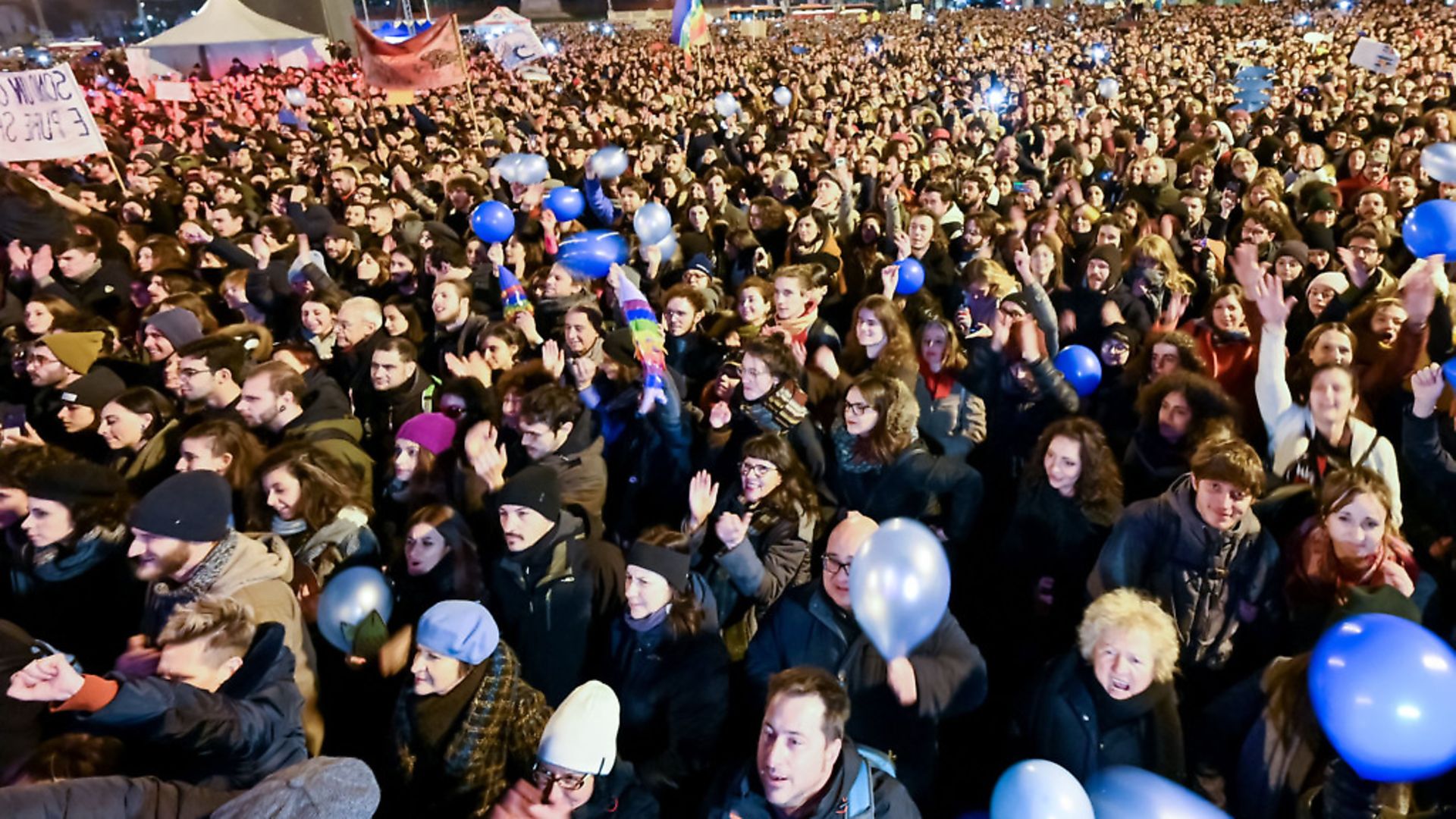 People attend a rally of the anti-fascist "Sardine Movement", formed to oppose the far-right League party, on January 19, 2020 in Bologna, a week ahead of Emilia-Romagna's regional vote. - Italy's youth-driven "Sardine Movement", formed to oppose the far-right League party, was launched by four little-known youths saying the anti-immigration League party led by Matteo Salvini represents hate and exclusion. Photo by ANDREAS SOLARO/AFP via Getty Images - Credit: AFP via Getty Images