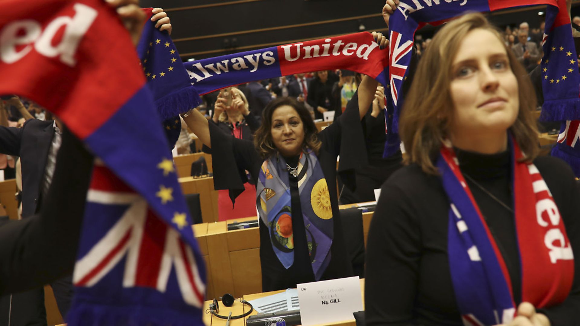 MEs hold up scarves during a ceremony prior to the vote on the UK's withdrawal from the EU. (AP Photo/Francisco Seco) - Credit: AP