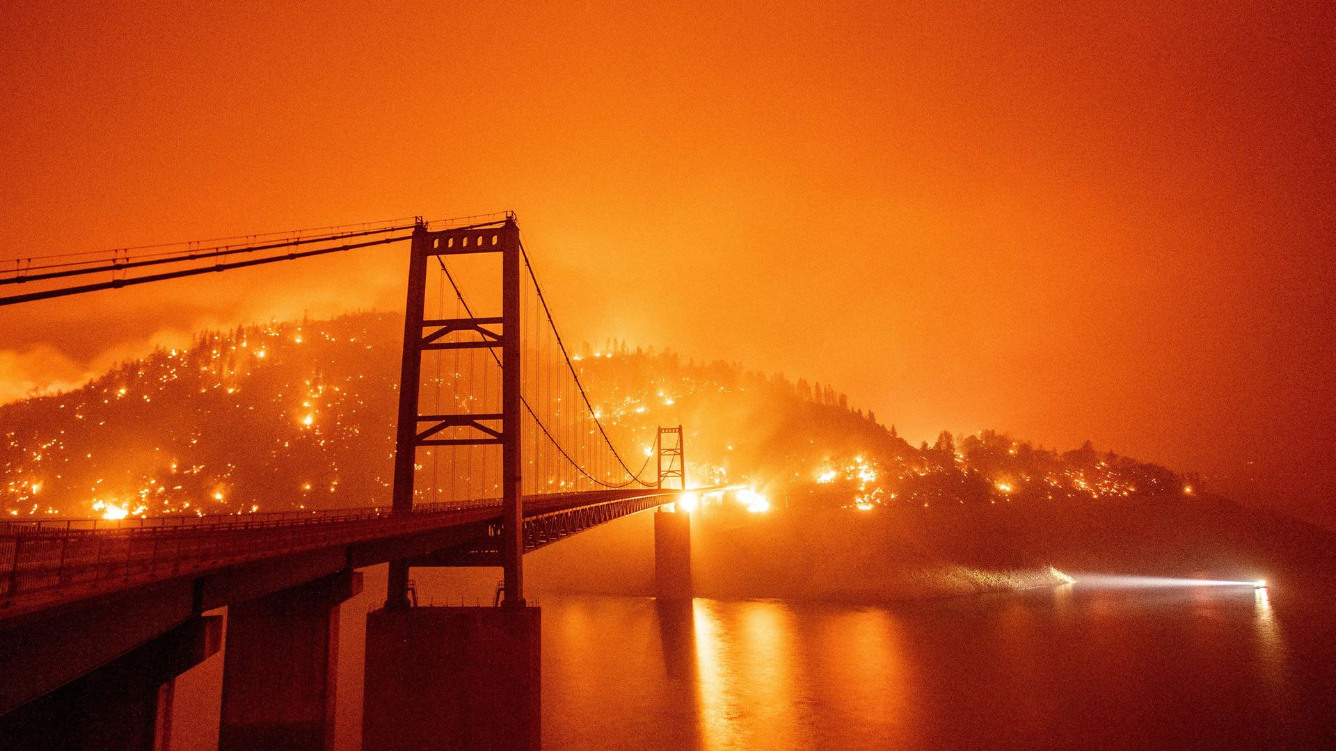 The Bidwell Bar Bridge over Lake Oroville, California, during forest fires in September 2020 - Credit: AFP via Getty Images