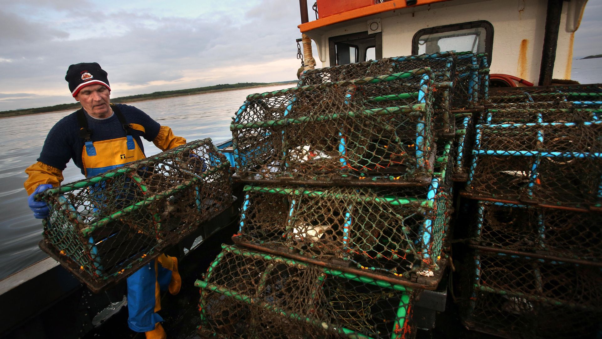 Lobster pots are stacked as Scottish inshore fishermen work off the east coast of Scotland, near Bass rock. - Credit: PA