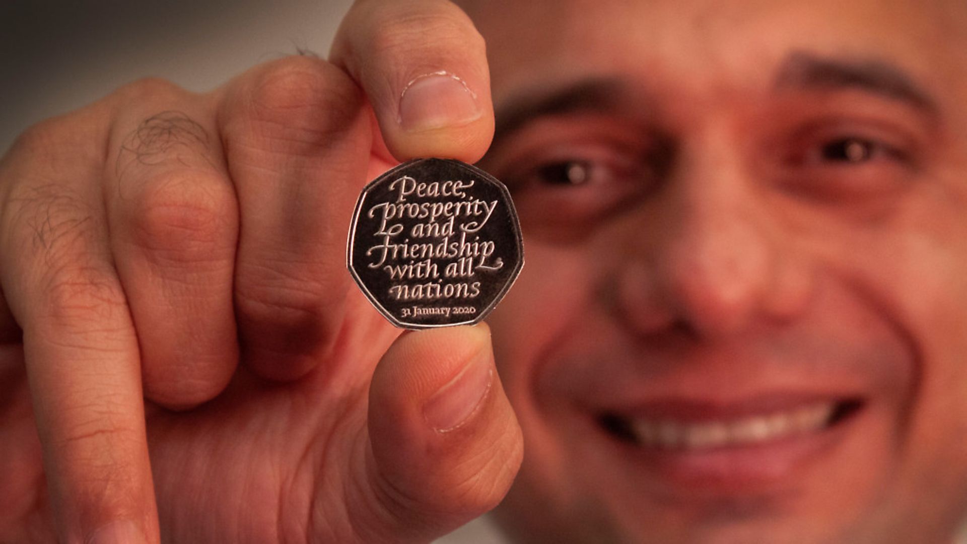 Former chancellor Sajid Javid holding the Brexit coin, a 50p bearing the inscription 'Peace, prosperity and friendship with all nations' and the date the UK leaves the EU.  Photograph: HM Treasury/PA. - Credit: PA