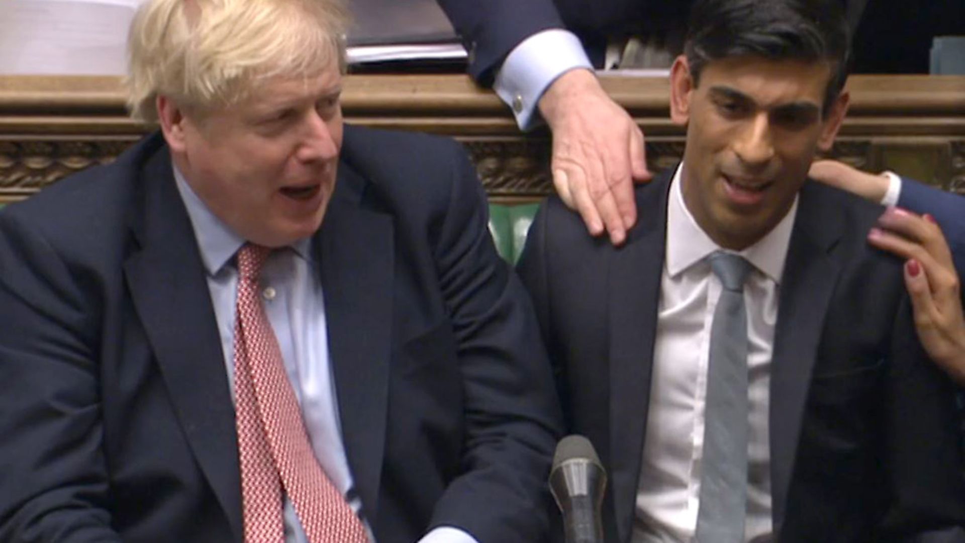 Chancellor Rishi Sunak (right) sits down after delivering his Budget in the House of Commons, London. Photograph: House of Commons/PA Wire. - Credit: PA