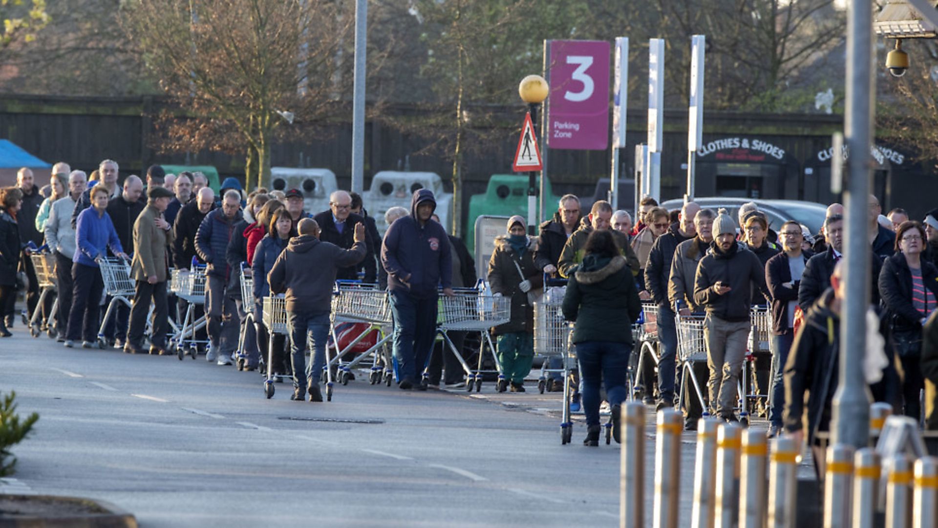 Customers form a queue at the Tesco store in Mather Avenue, Liverpool, ahead of it opening. Photograph: Peter Byrne/PA Wire. - Credit: PA