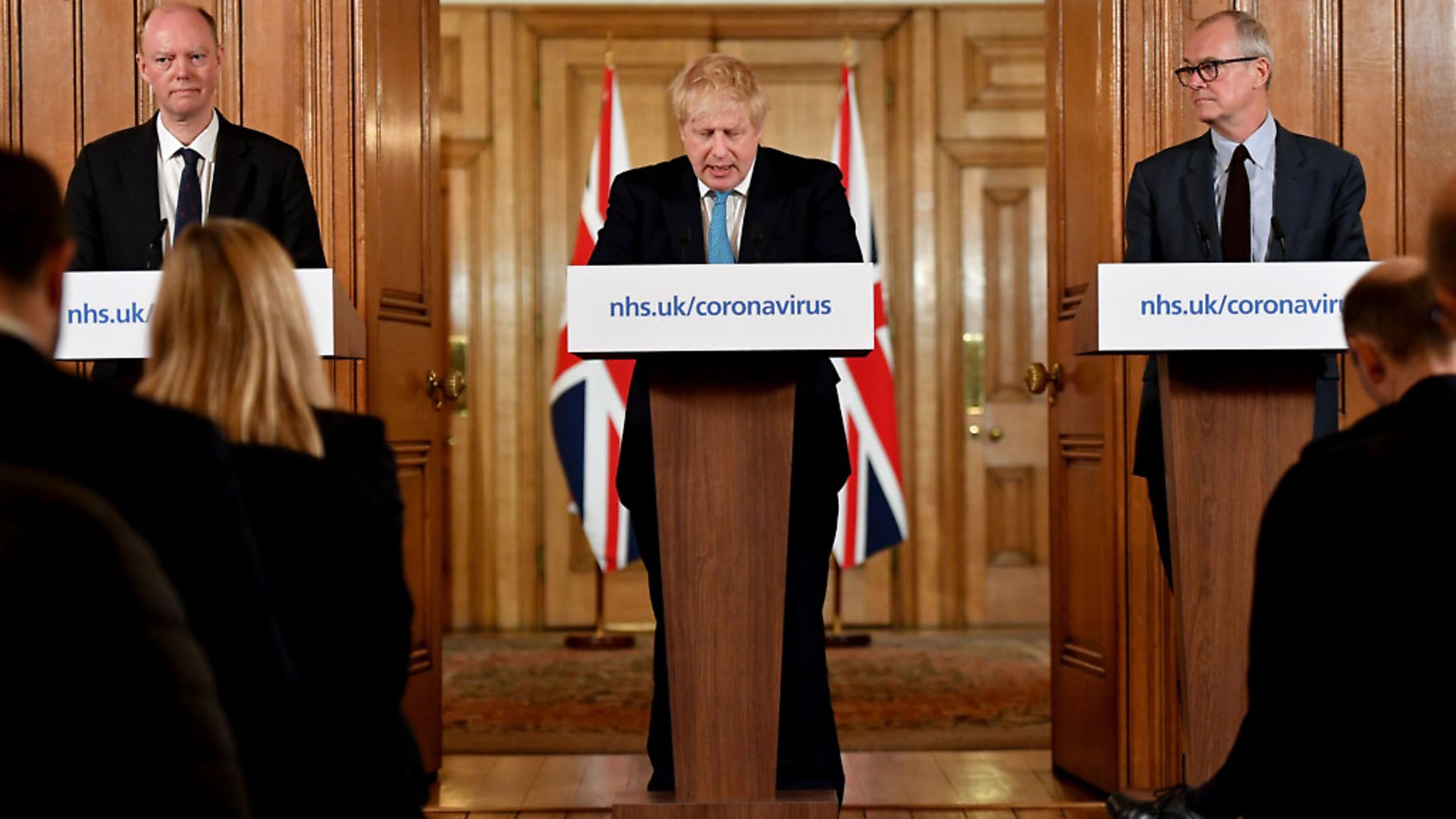 Chief Medical Officer Professor Chris Whitty (left) and Chief Scientific Adviser Patrick Vallance (right) watch as Prime Minister Boris Johnson gestures as he speaks during a coronavirus news conference inside 10 Downing Street, London. Photograph: Leon Neal/PA Wire - Credit: PA