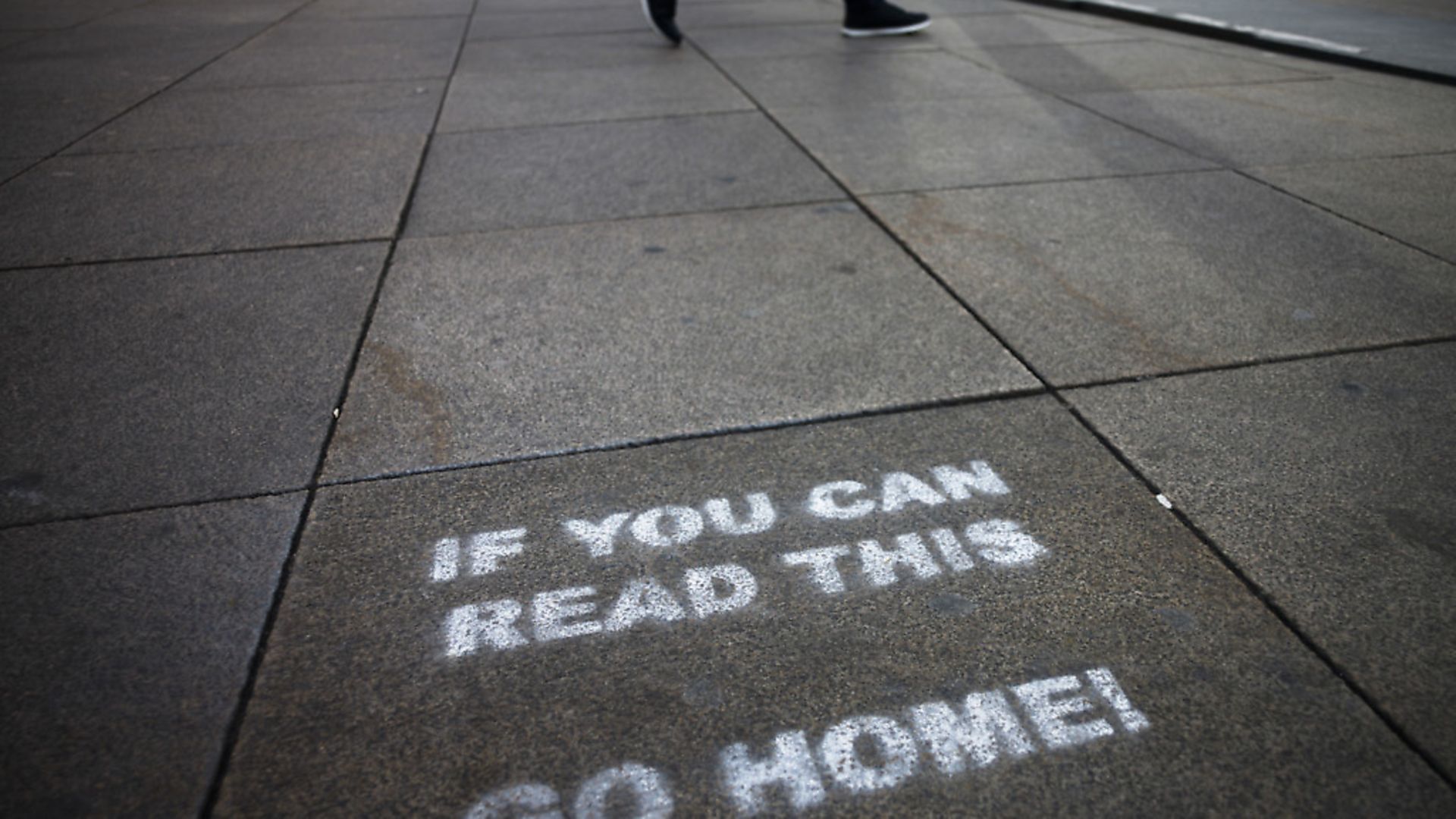A a message demanding the people to go home is sprayed on the ground of Alexanderplatz square in Berlin, Germany. Photograph: AP Photo/Markus Schreiber. - Credit: AP