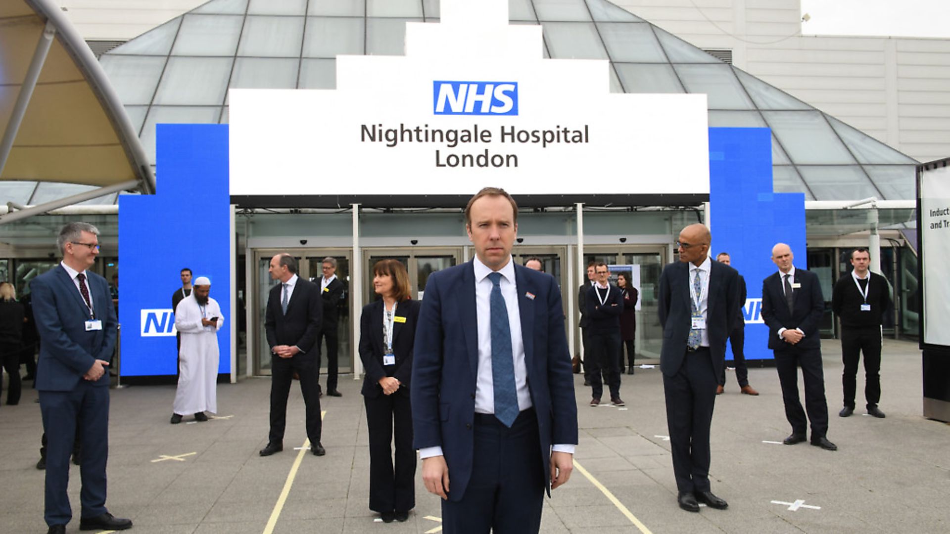Health Secretary Matt Hancock and NHS staff stand on marks on the ground, put in place to ensure social distancing guidelines are adhered to. Photograph: Stefan Rousseau/PA Wire - Credit: PA