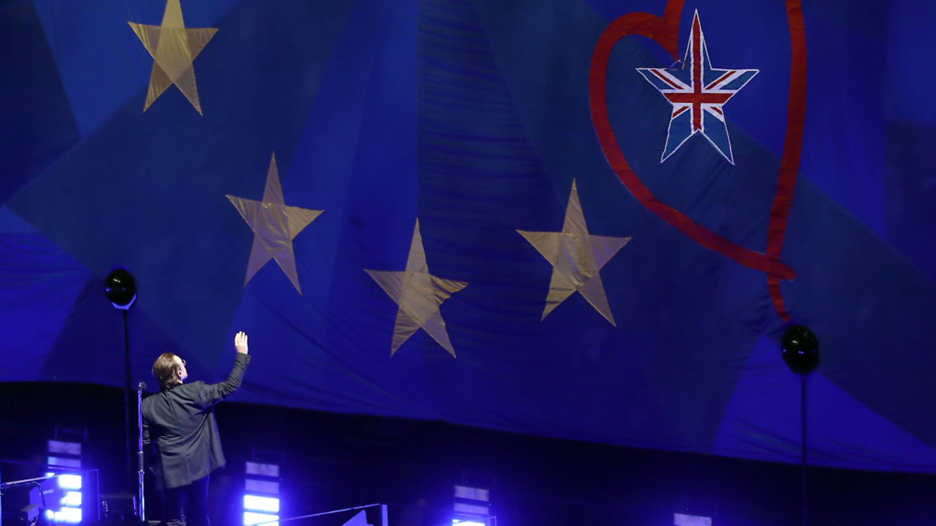 U2's Bono waves to a giant EU flag, with one star as the Union Flag, at the o2 Arena in London, during their eXPERIENCE + iNNOCENCE Tour. Photograp: Andrew Matthews/PA. - Credit: PA