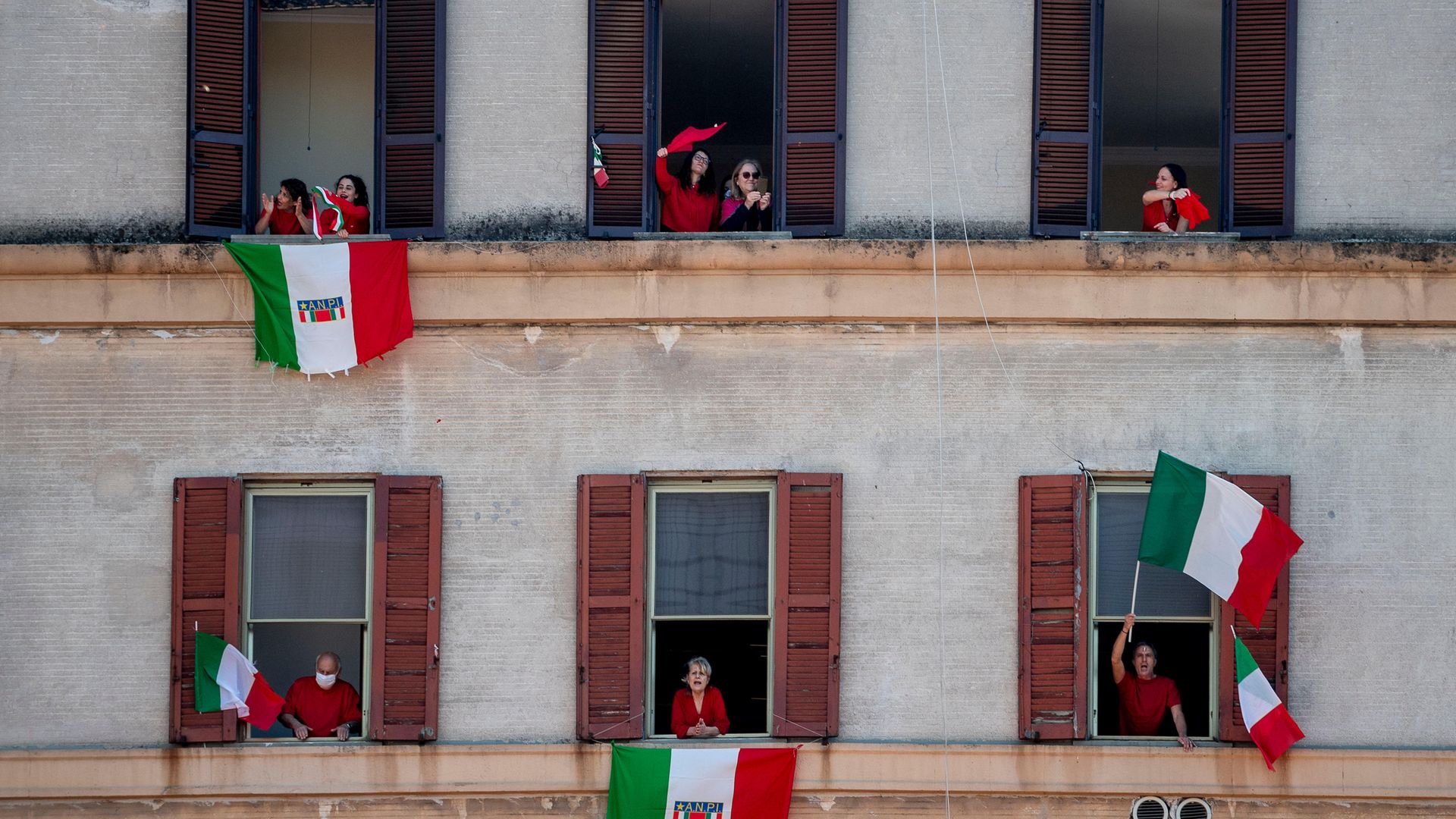 Residents in Rome take part in a communal singing event, during Italy's first lockdown, in April 2020 - Credit: Getty Images