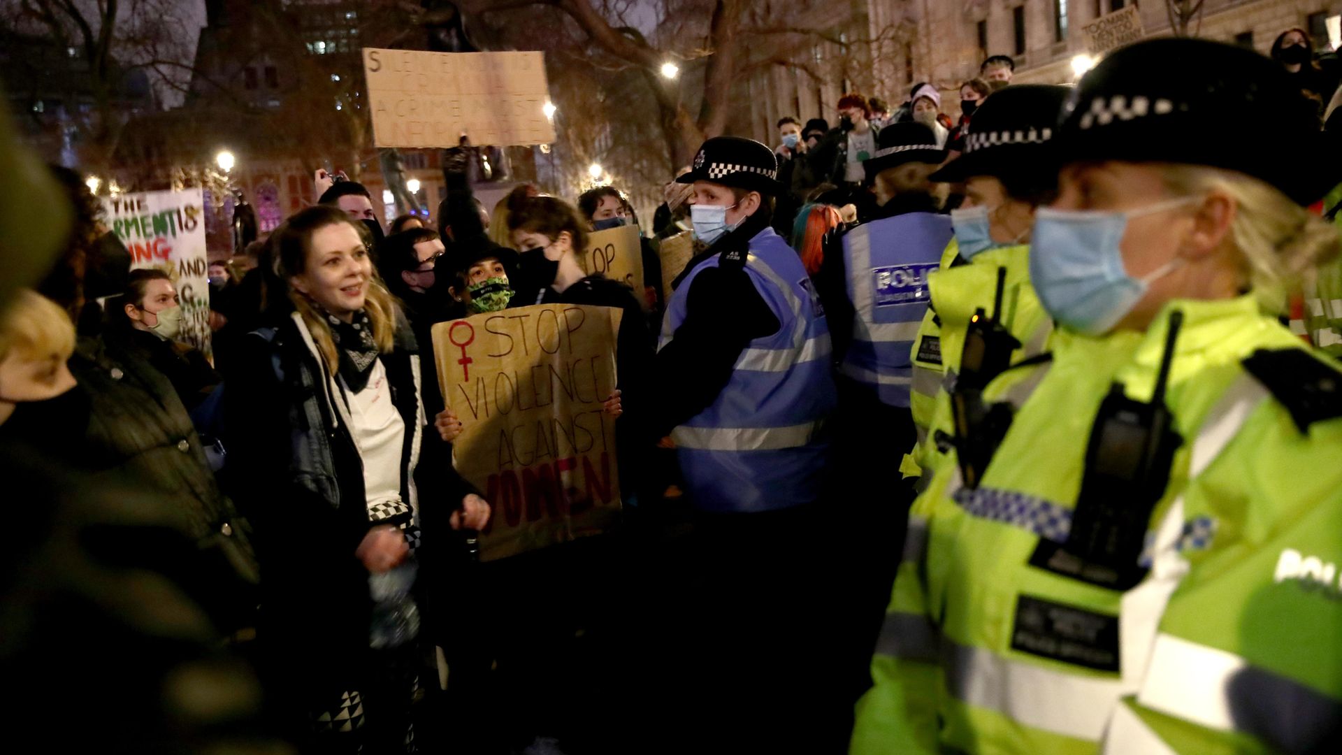 Police watch the crowd at Parliament Square in London, the day after clashes between police and crowds who gathered on Clapham Common on Saturday night to remember Sarah Everard - Credit: PA