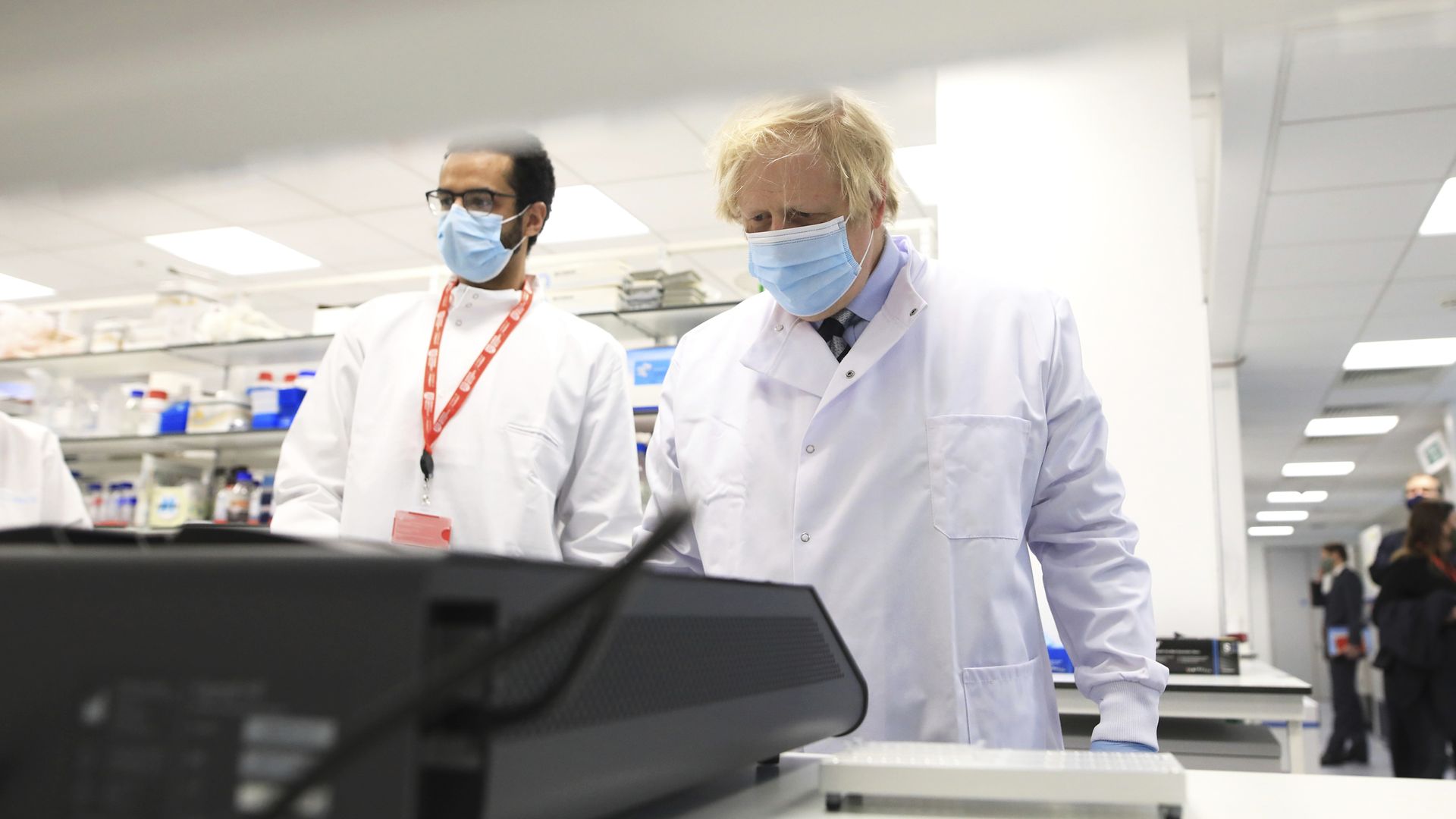 Prime minister Boris Johnson (right) is shown the latest technology by PHD student Ahmed Elkaskis during a visit to the Wellcome-Wolfson Institute For Experimental Medicine at Queen's University Belfast in Northern Ireland - Credit: PA