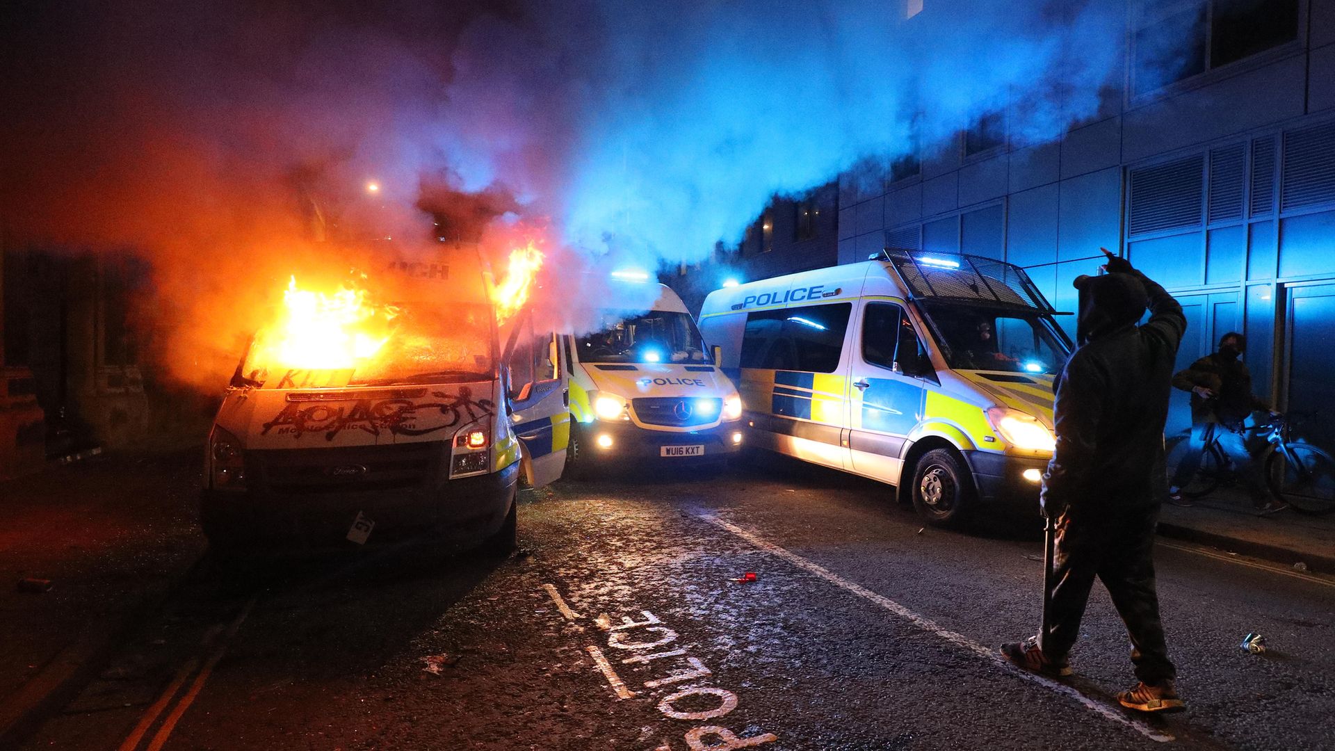 A vandalised police van on fire outside Bridewell Police Station, as other police vehicles arrive after protesters demonstrated against the Government's controversial Police and Crime Bill - Credit: PA