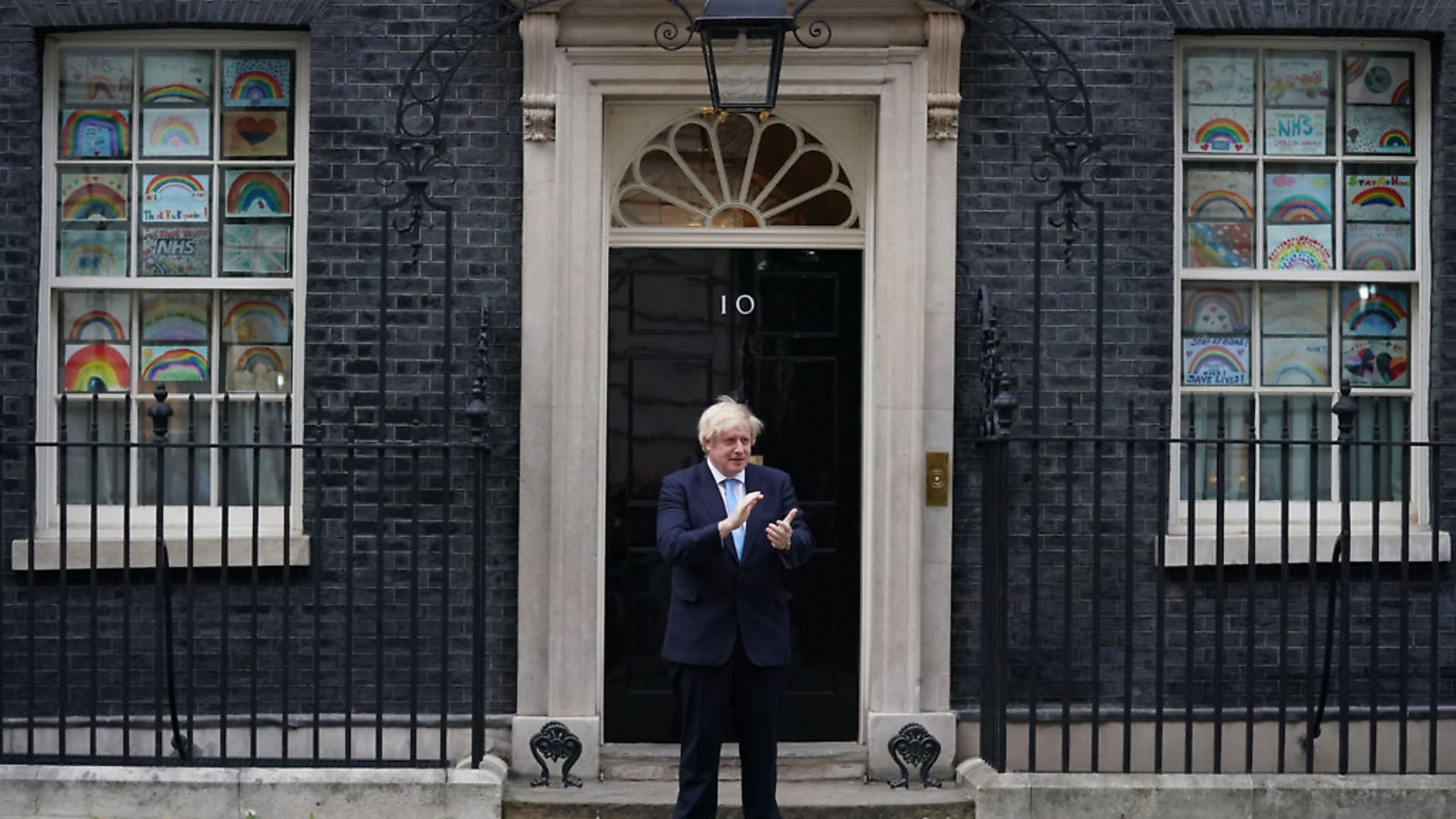 Prime Minister Boris Johnson stands in Downing Street to join in the applause to salute local heroes during Thursday's nationwide Clap for Carers. Photograph: Aaron Chown/PA Wire. - Credit: PA
