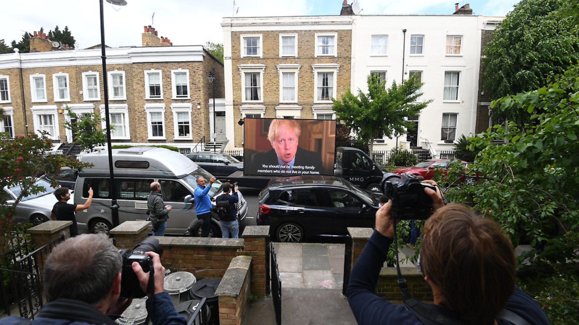 A video by political campaign group Led By Donkeys of the statement made by Prime Minister Boris Johnson is shown outside the north London home of his senior aide Dominic Cummings. Photograph: PA. - Credit: PA