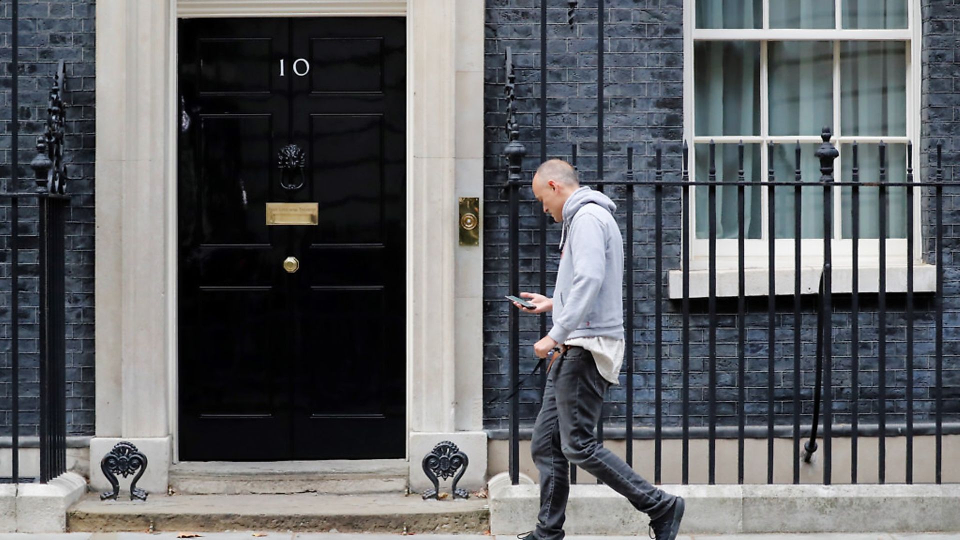 Special Advisor to Britain's Prime Minister, Dominic Cummings, uses his phone as he returns back to 10 Downing Street. (TOLGA AKMEN/AFP/Getty Images) - Credit: AFP/Getty Images
