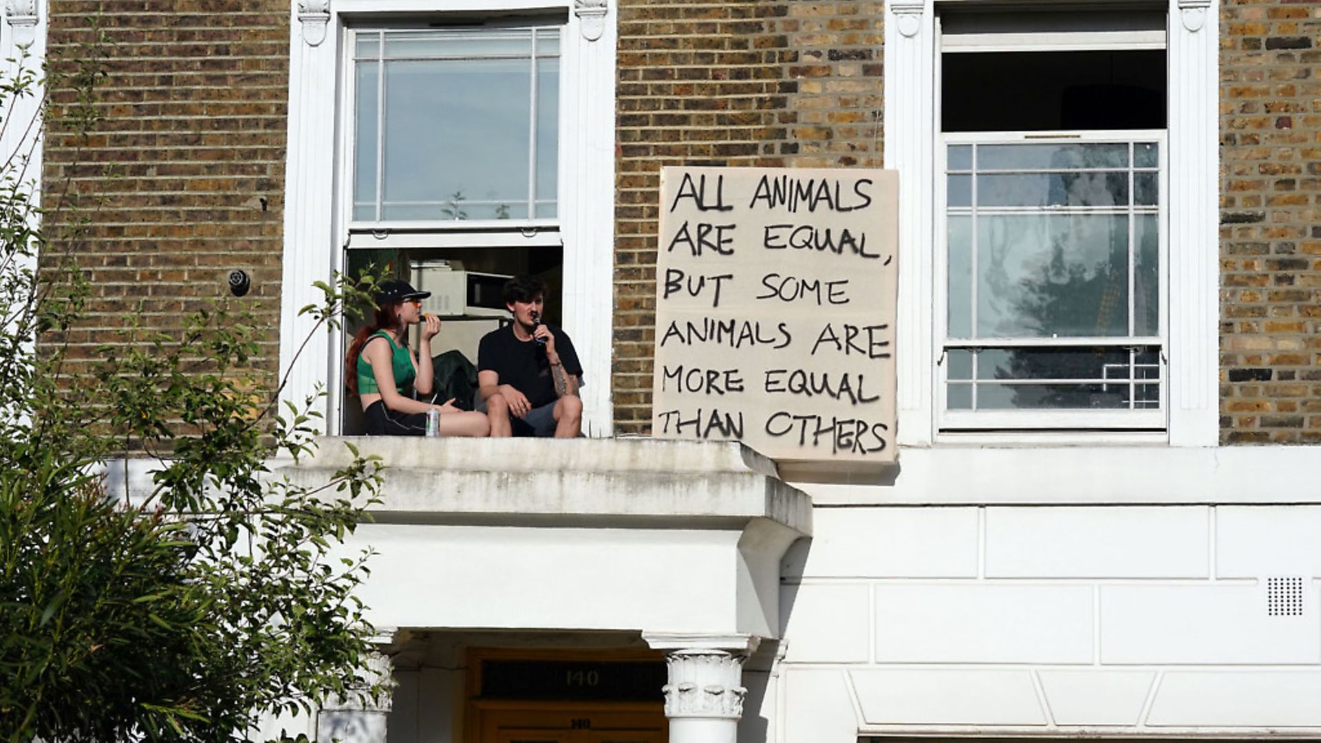 Protesters hang out a sign in the same street of where Boris Johnson's senior aide Dominic Cummings has his north London home. Photograph: Aaron Chown/PA Wire. - Credit: PA