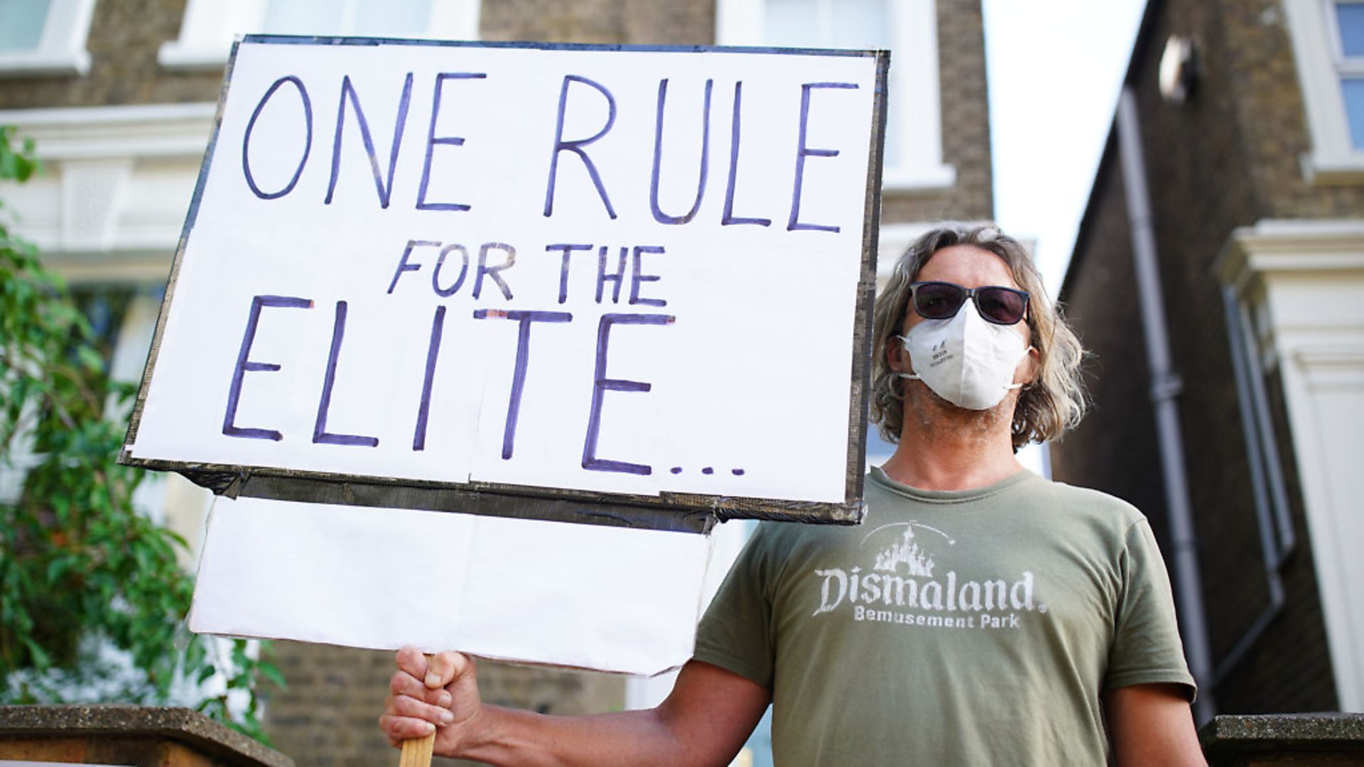 A protester outside the north London home of Prime Minister Boris Johnson's senior aide Dominic Cummings after he gave a press conference over allegations he breached coronavirus lockdown restrictions. PA Photo. Picture date: Monday May 25, 2020. See PA story HEALTH Coronavirus. Photo credit should read: Aaron Chown/PA Wire - Credit: PA