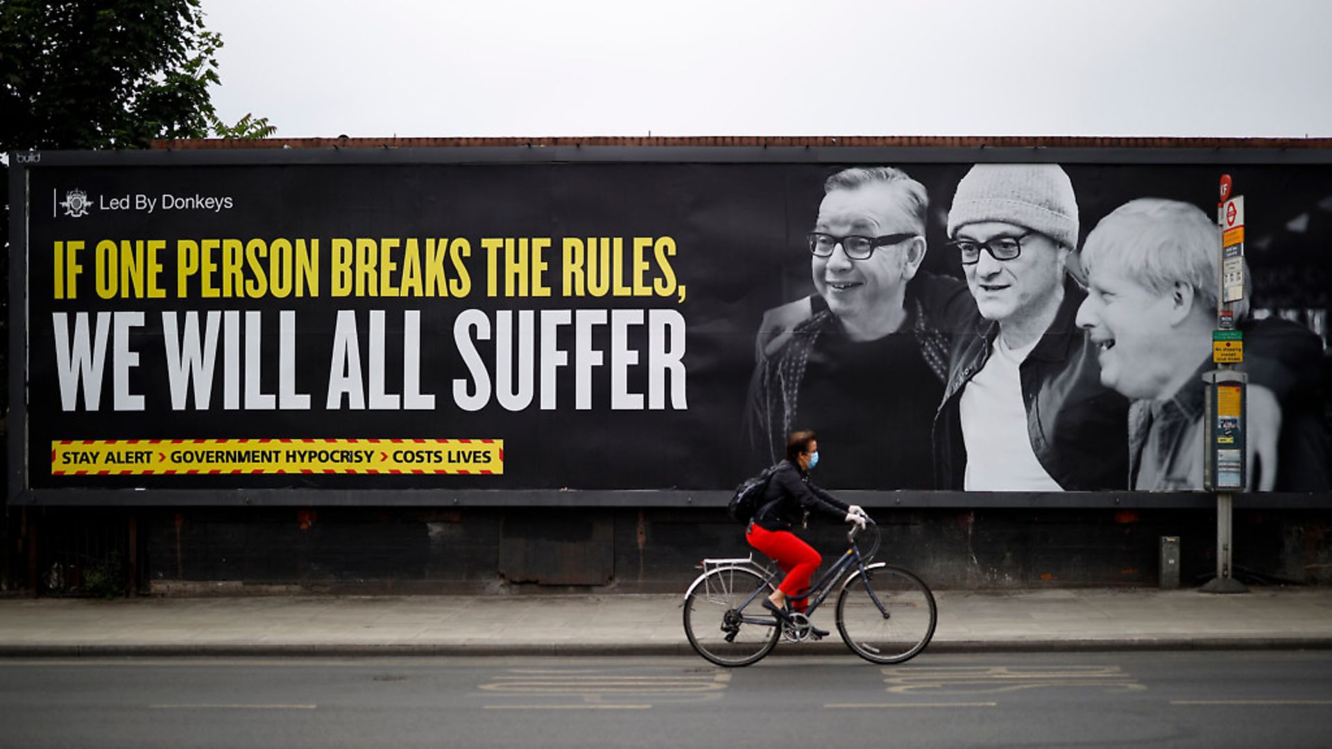 The billboard, exposing the government's hypocrisy over Dominic Cummings, was posted by political campaign group 'Led By Donkeys' in Kentish Town. Photo by TOLGA AKMEN/AFP via Getty Images - Credit: AFP via Getty Images