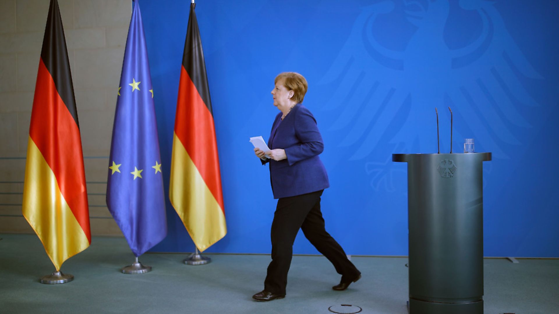 German Chancellor Angela Merkel leaves after addressing a press conference following a meeting  (Photo by ODD ANDERSEN/AFP via Getty Images) - Credit: AFP via Getty Images