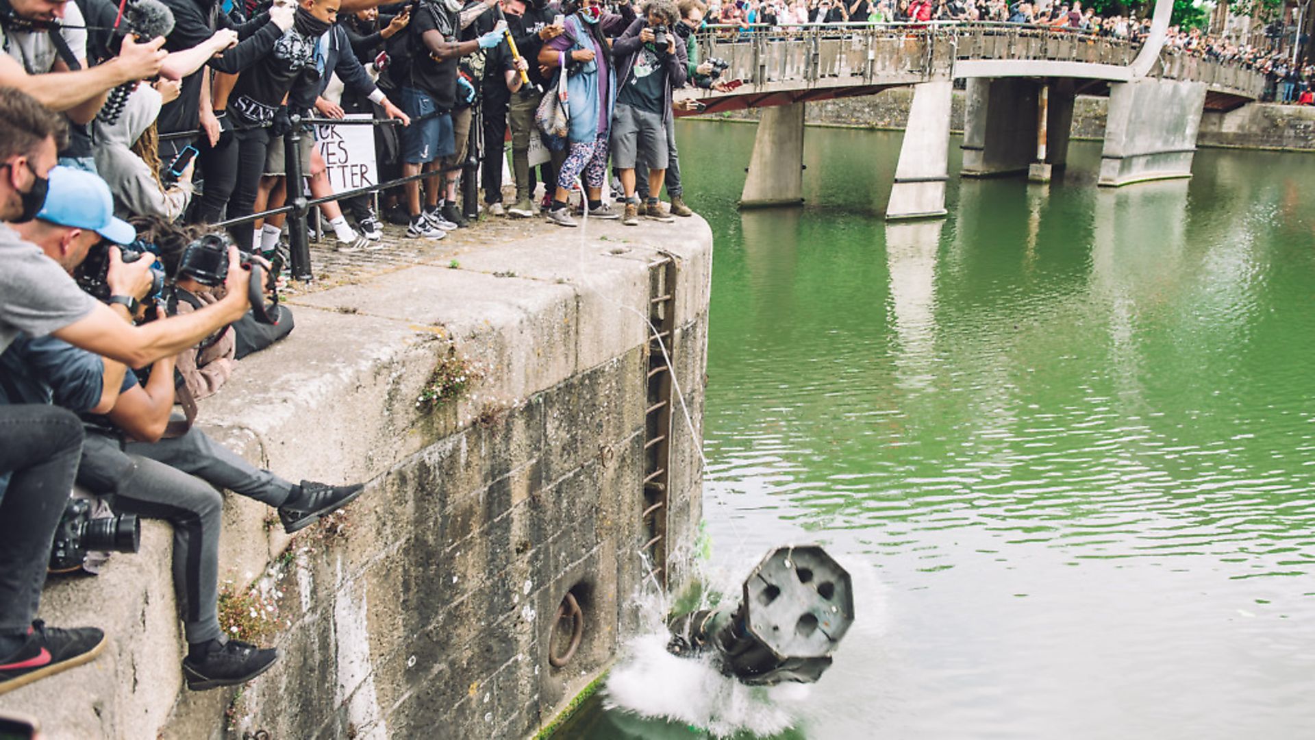 The statue of Colston is pushed into the river Avon. Edward Colston was a slave trader of the late 17th century who played a major role in the development of the city of Bristol, England, on June 7, 2020. (Photo by Giulia Spadafora/NurPhoto via Getty Images) - Credit: NurPhoto via Getty Images