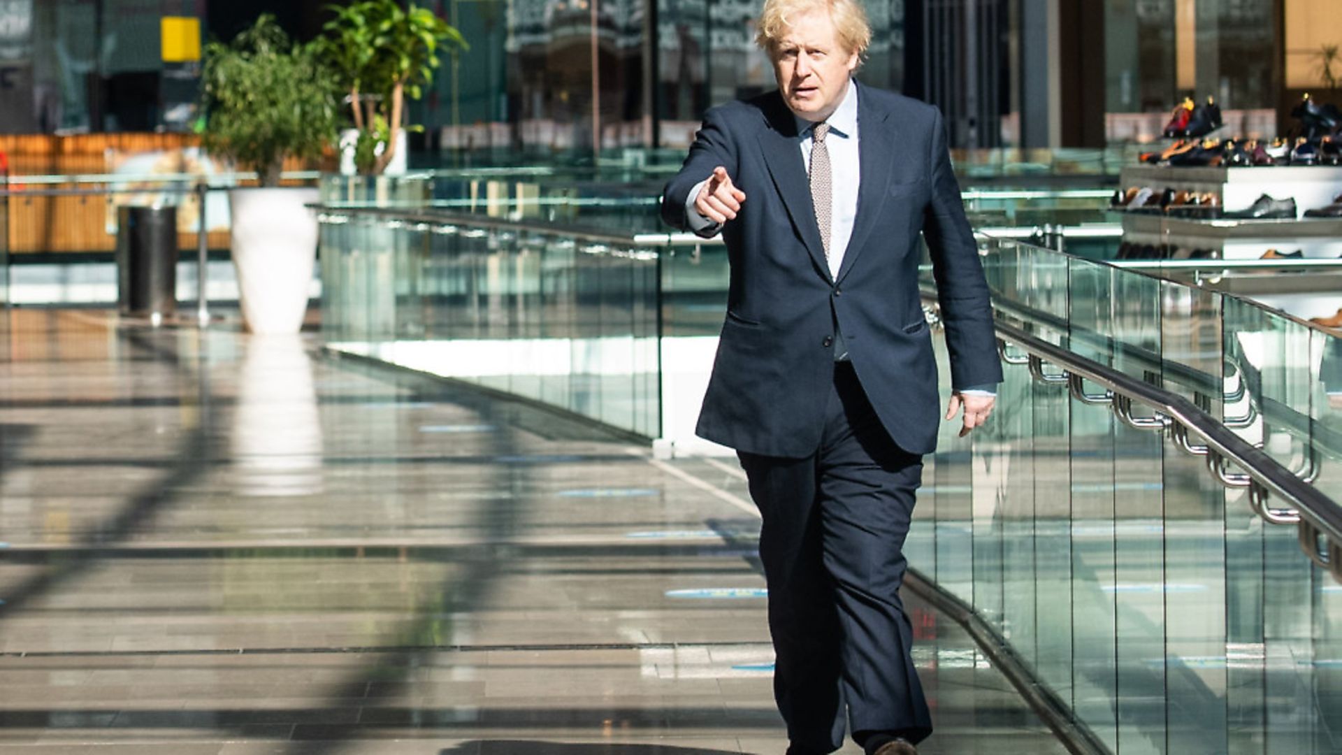Boris Johnson visits a shopping centre in east London on June 14 to see the coronavirus measures. But not everyone is happy with his roadmap for the lifting of lockdown. Photo: JOHN NGUYEN/POOL/AFP via Getty Images) - Credit: POOL/AFP via Getty Images