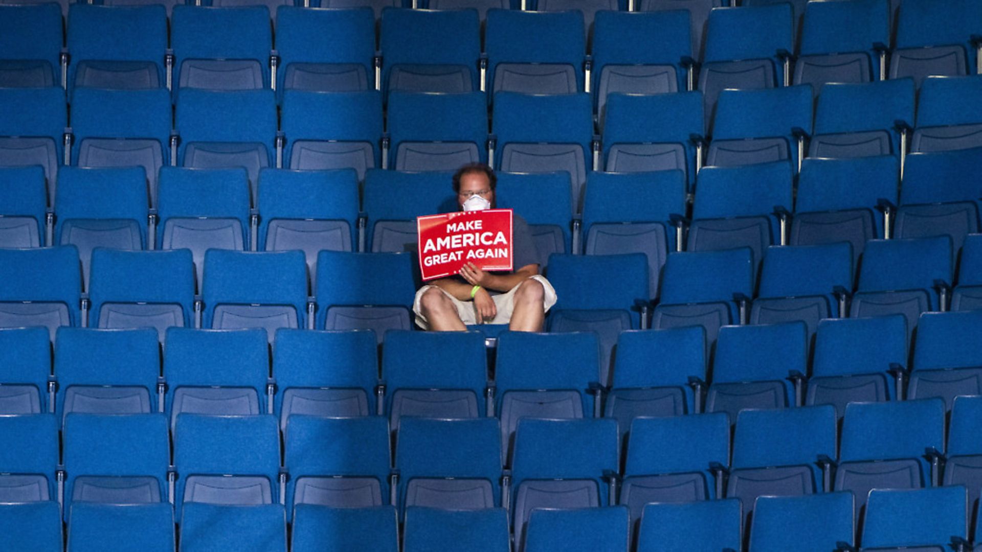 TULSA, OK - JUNE 20: A supporter sits alone in the top sections of seating as Vice President Mike Pence speaks before President Donald J. Trump arrives for a "Make America Great Again!" rally at the BOK Center on Saturday, June 20, 2020 in Tulsa, OK. (Photo by Jabin Botsford/The Washington Post via Getty Images) - Credit: The Washington Post via Getty Im