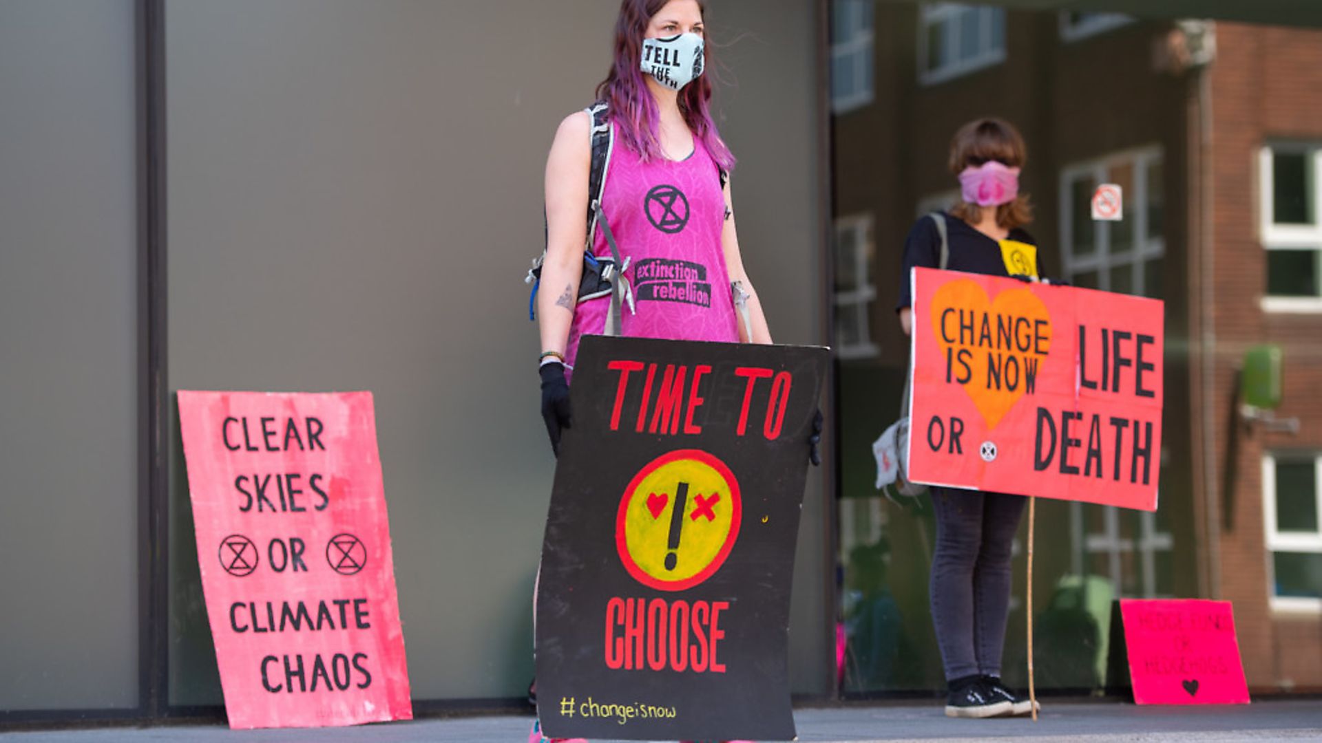 Extinction Rebellion activists stage a socially distanced protest outside the Woolwich Centre, in south London, calling on the council to better respond to Covid-19 and climate change. Photograph: Dominic Lipinski/PA. - Credit: PA