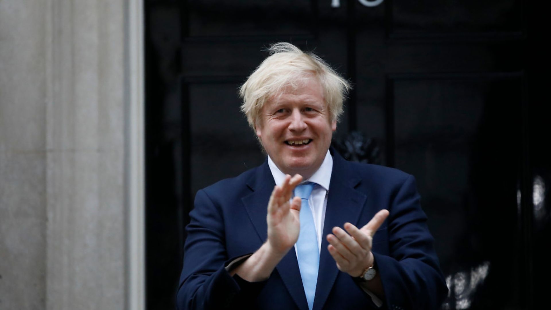 Britain's Prime Minister Boris Johnson participate in a national "clap for carers" to show thanks for the work of Britain's NHS (National Health Service) workers (Photo by TOLGA AKMEN/AFP via Getty Images) - Credit: AFP via Getty Images