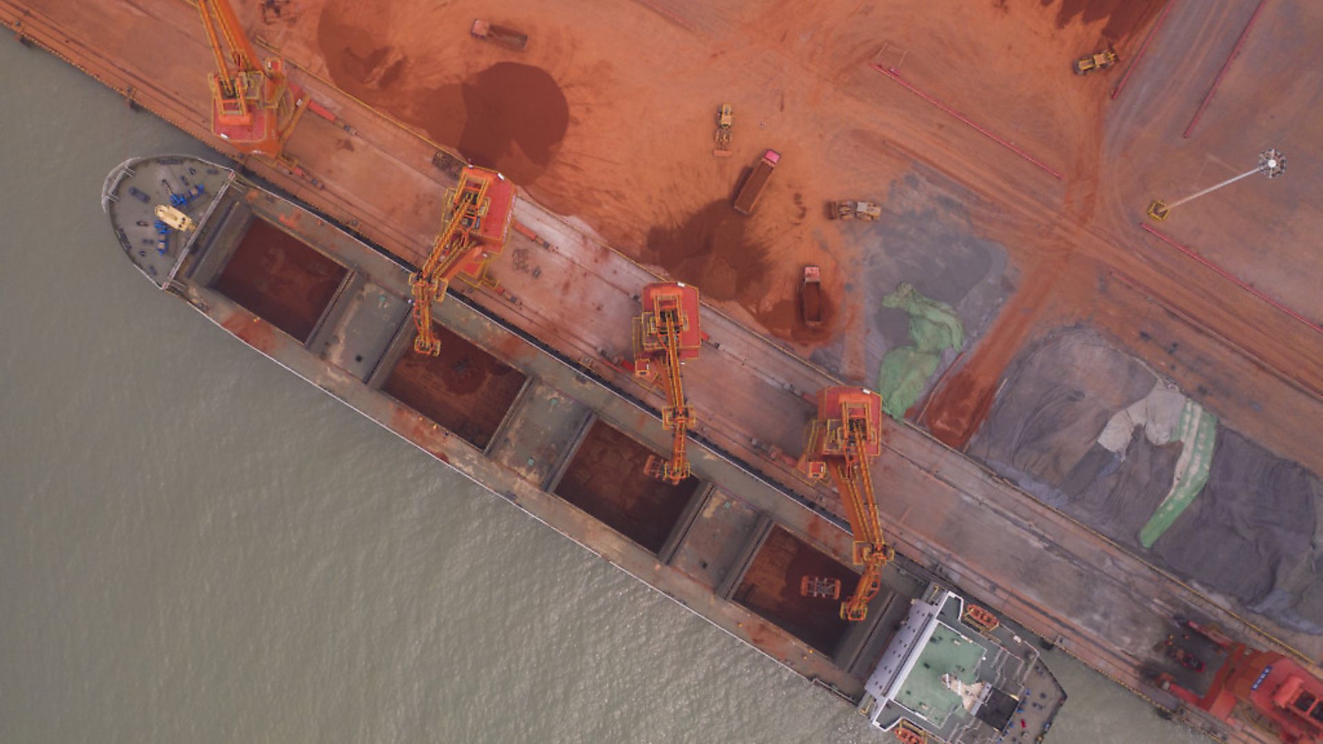 Aerial view of cranes loading aluminous soil imported from Guinea at Binzhou Port on June 19, 2019 in Binzhou, Shandong Province of China. Photo: Fu Kun/Visual China Group via Getty Images - Credit: Visual China Group via Getty Ima