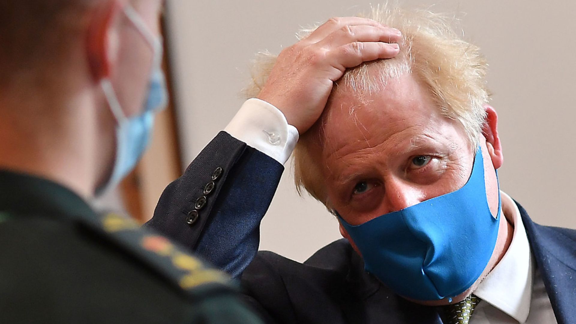 Prime Minister Boris Johnson, wearing a face mask, talks with a paramedic during a visit to the headquarters of the London Ambulance Service NHS Trust. Photograph: Ben Stansall/PA Wire - Credit: PA