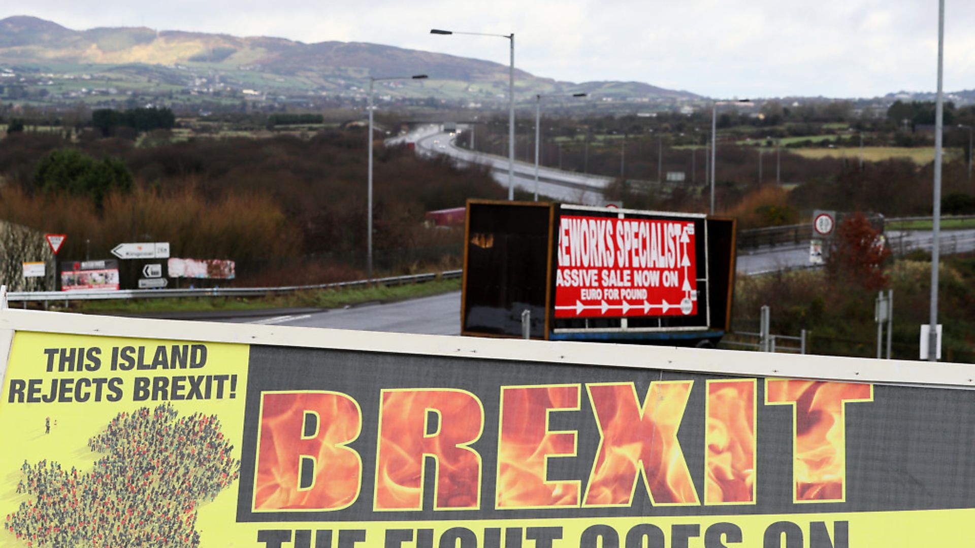 A Border Communities Against Brexit poster before its unveiling at a demonstration in Carrickcarnon on the Irish border. Photograph: Brian Lawless/PA. - Credit: PA